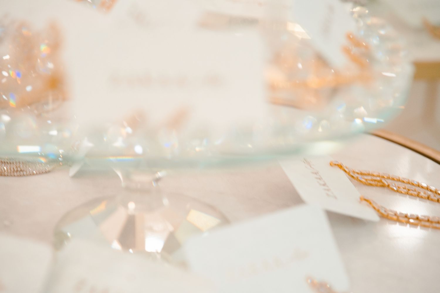 Delicate white silk ribbons and gold strings create an elegant textural background pattern in soft lighting.