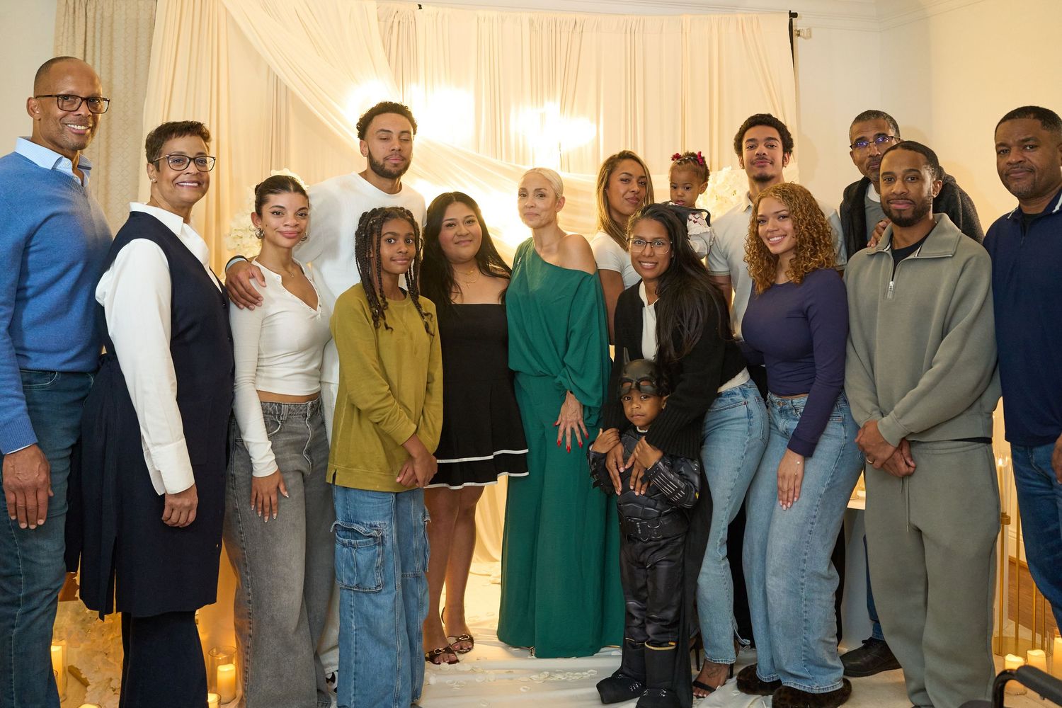 A group photo of diverse people standing together at a formal gathering.