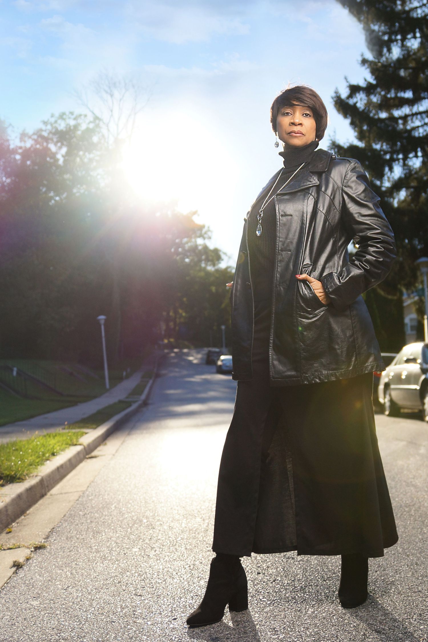 Dramatic outdoor portrait with leather coat in golden sunset lighting.