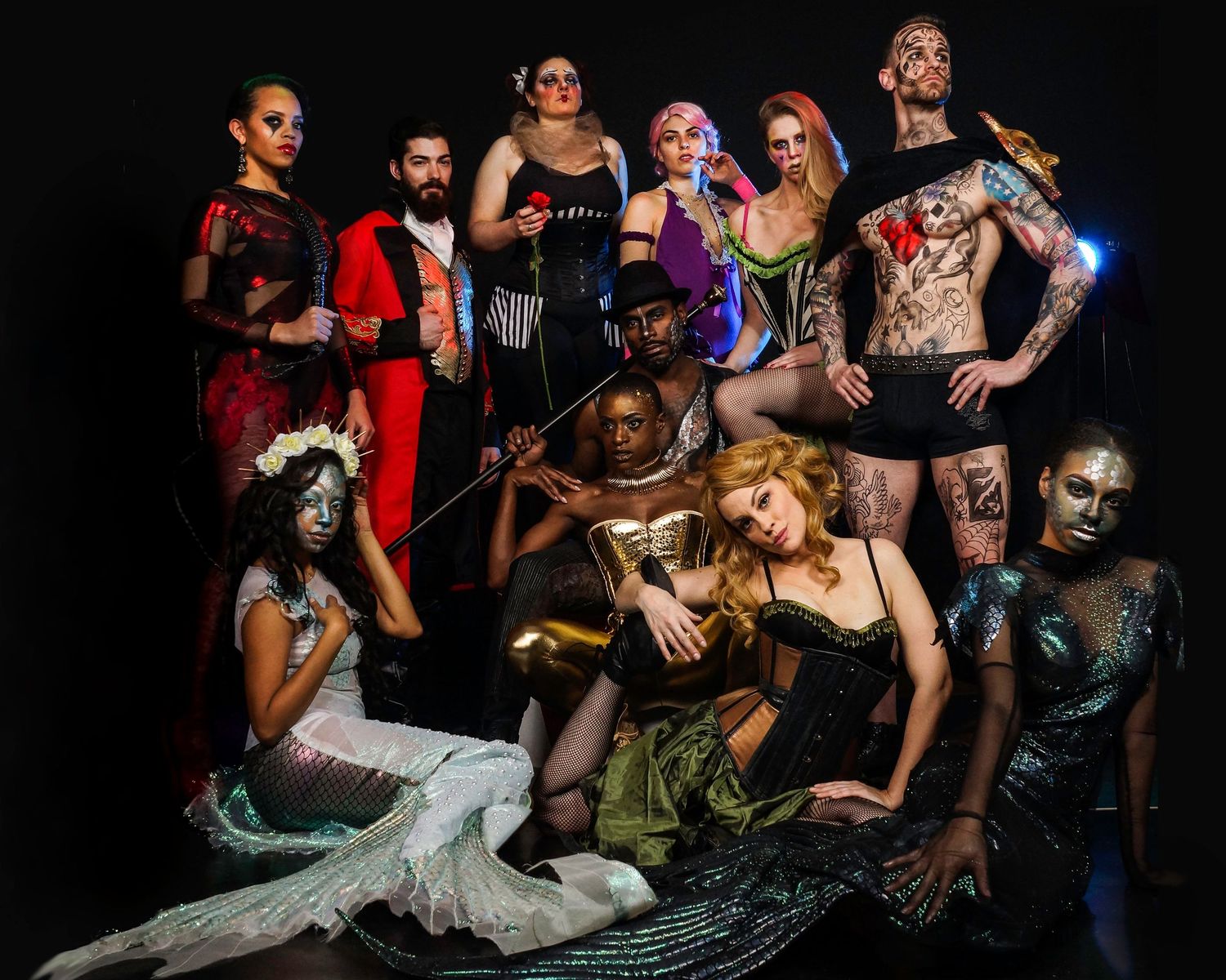 Artistic group performance scene captured in dramatic low-light conditions.