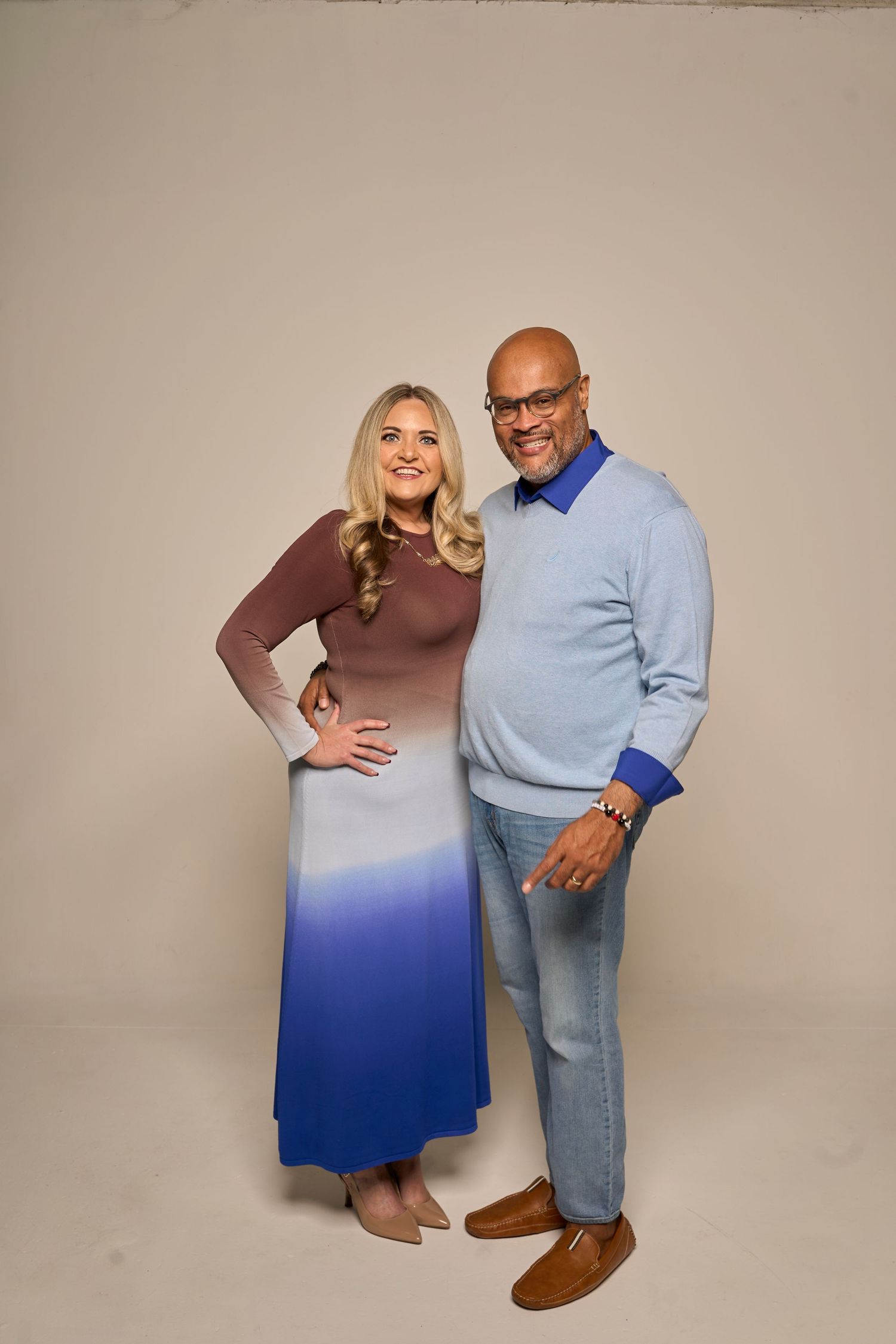 Studio photoshoot with ombre dress and light blue sweater against neutral background.