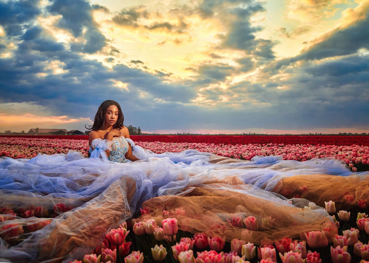 Dramatic sunset photoshoot series with flowing dresses against colorful sky backgrounds.