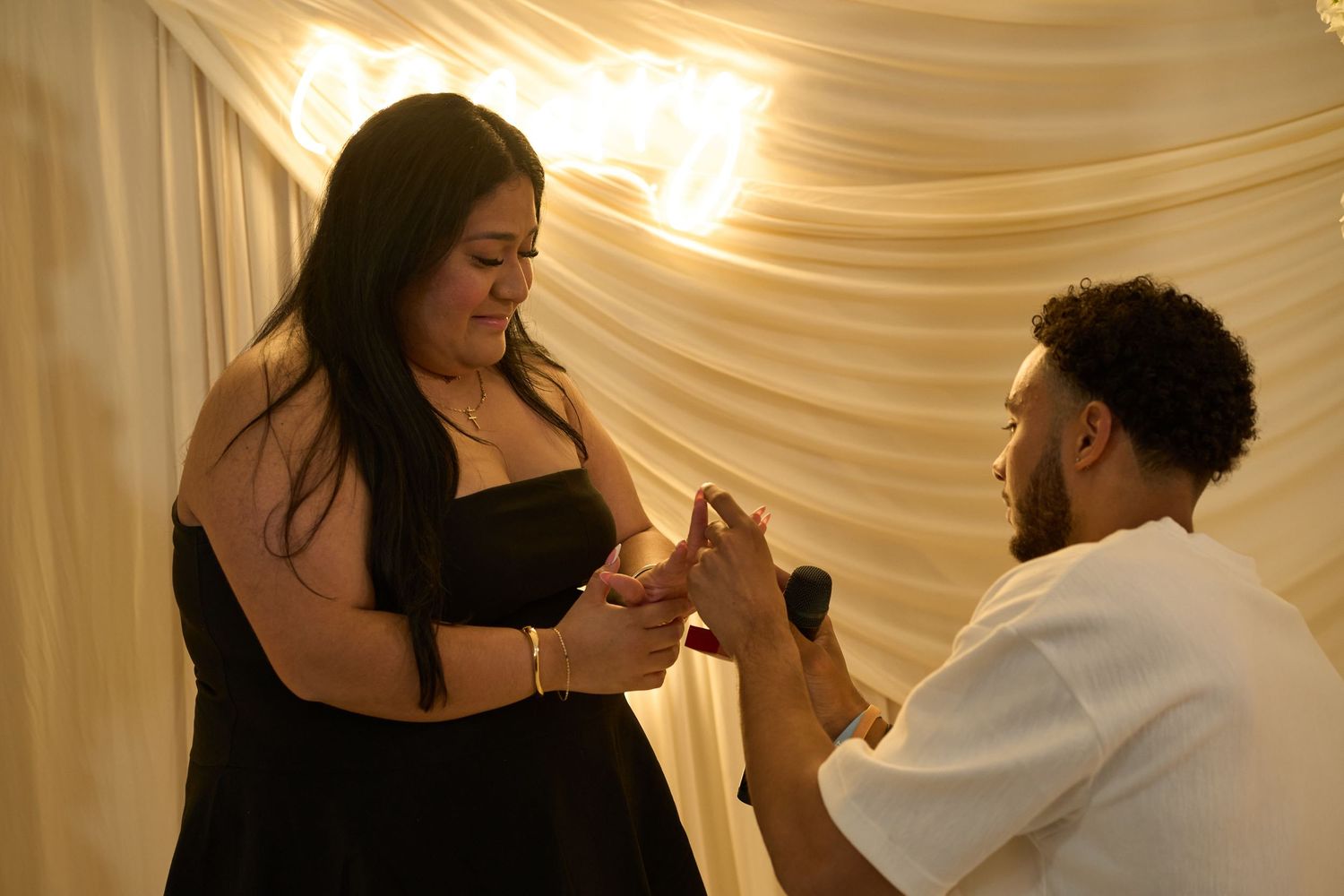 Elegant dance moves captured under draped white fabric ceiling with warm lighting.