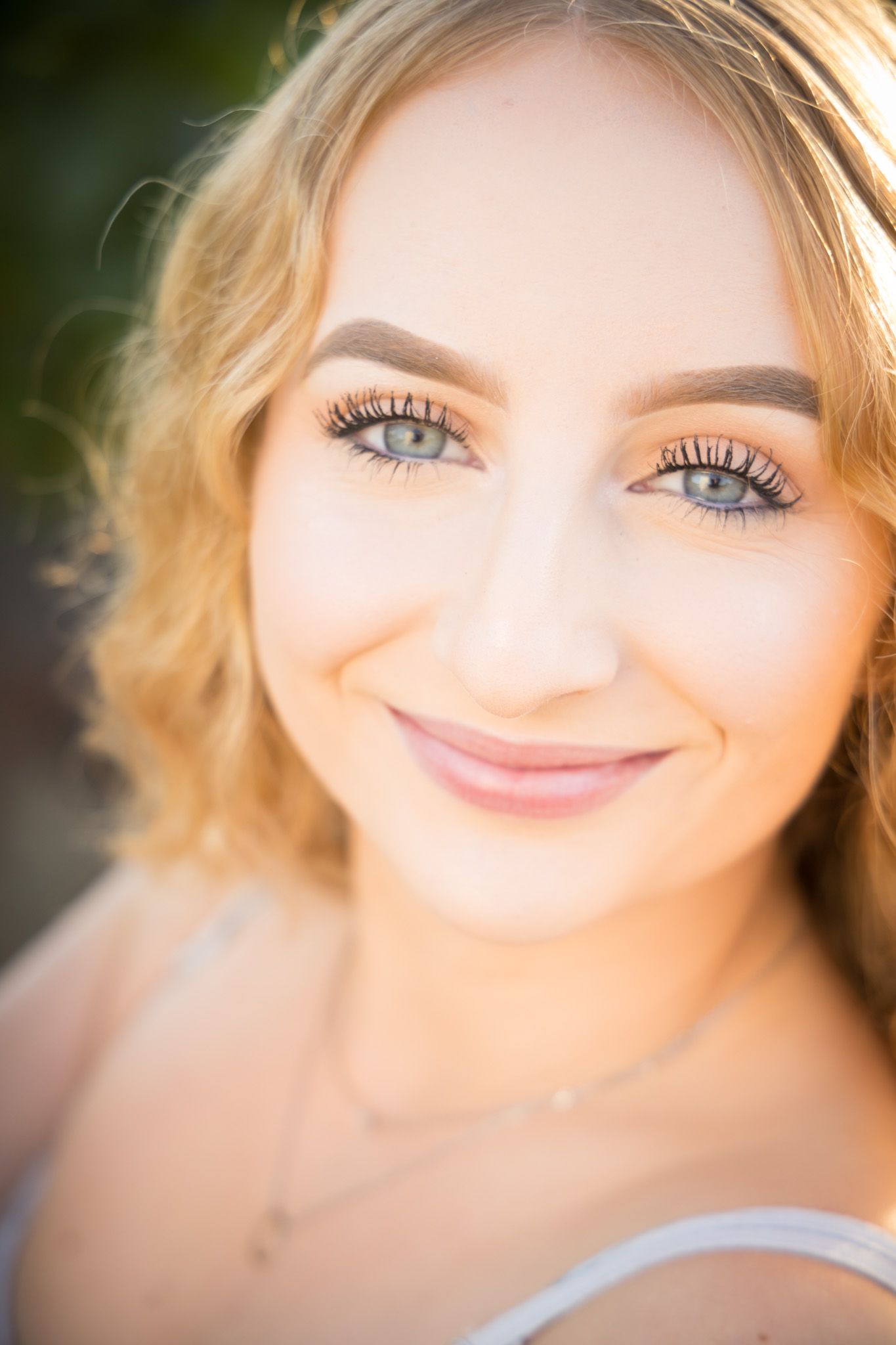 Close-up portrait with soft natural lighting and warm glowing skin creating a dreamy aesthetic effect.