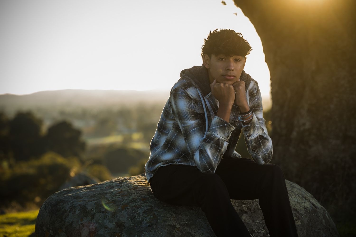 Senior Photos - Silhouette portrait against sunset with dramatic backlighting and natural outdoor scenery.