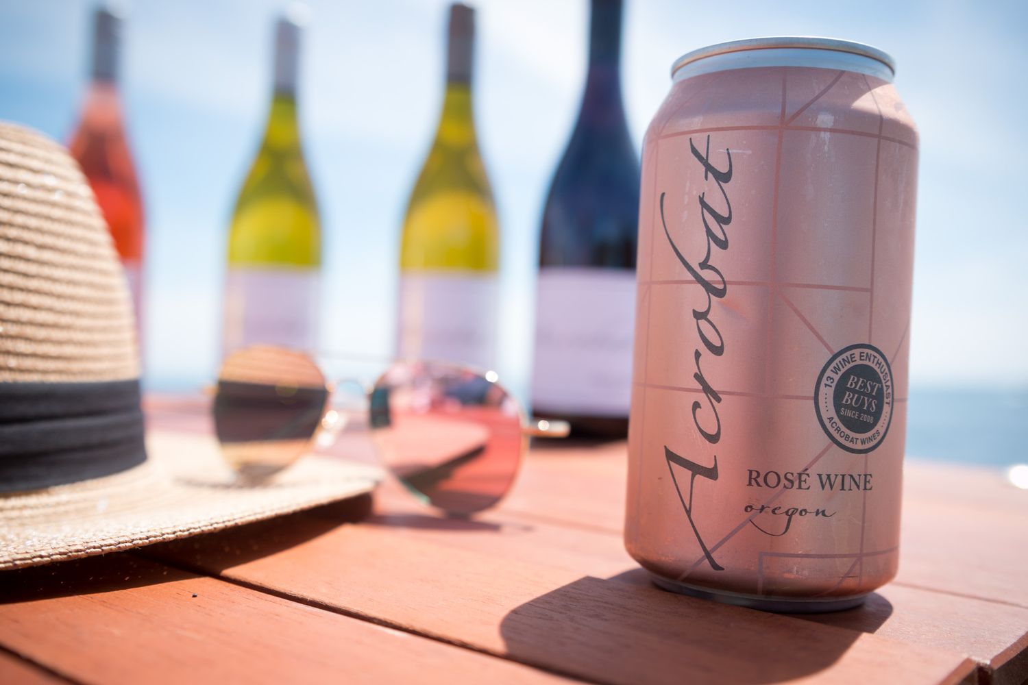 Closeup of canned wine products displayed with artistic labels in soft lighting.