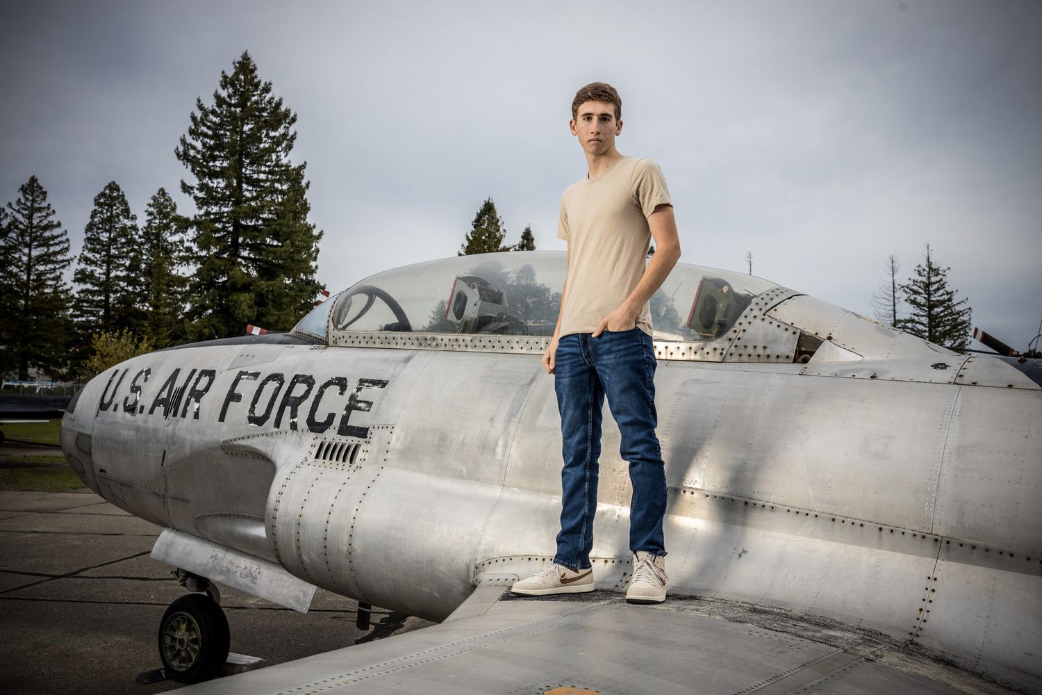 Senior Photos - Vintage US Air Force trainer aircraft on display with figure standing on top.