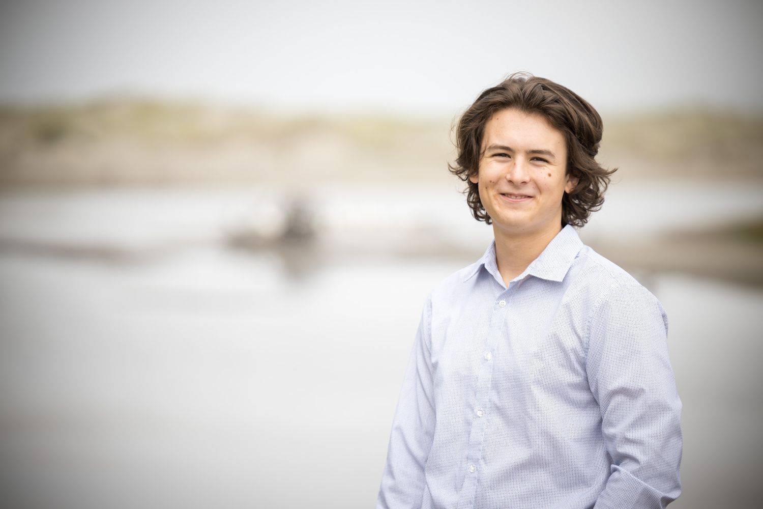 Casual outdoor portraits near beach with natural lighting and soft focus.