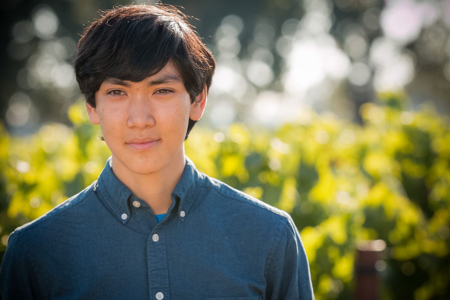 Portrait with yellow flowers and natural bokeh in background.