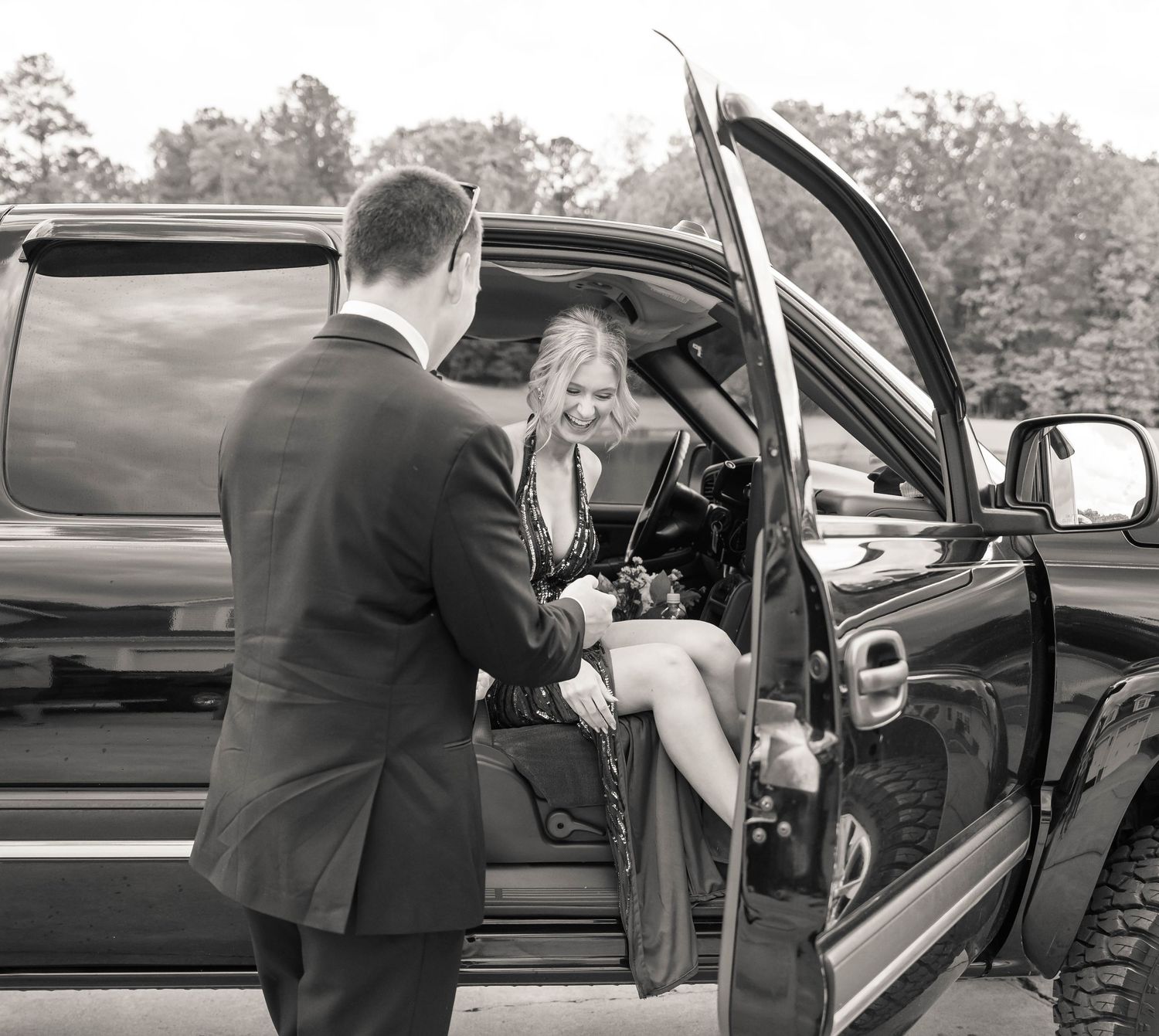 Black and white sequence showing assistance into vehicle at formal occasion.
