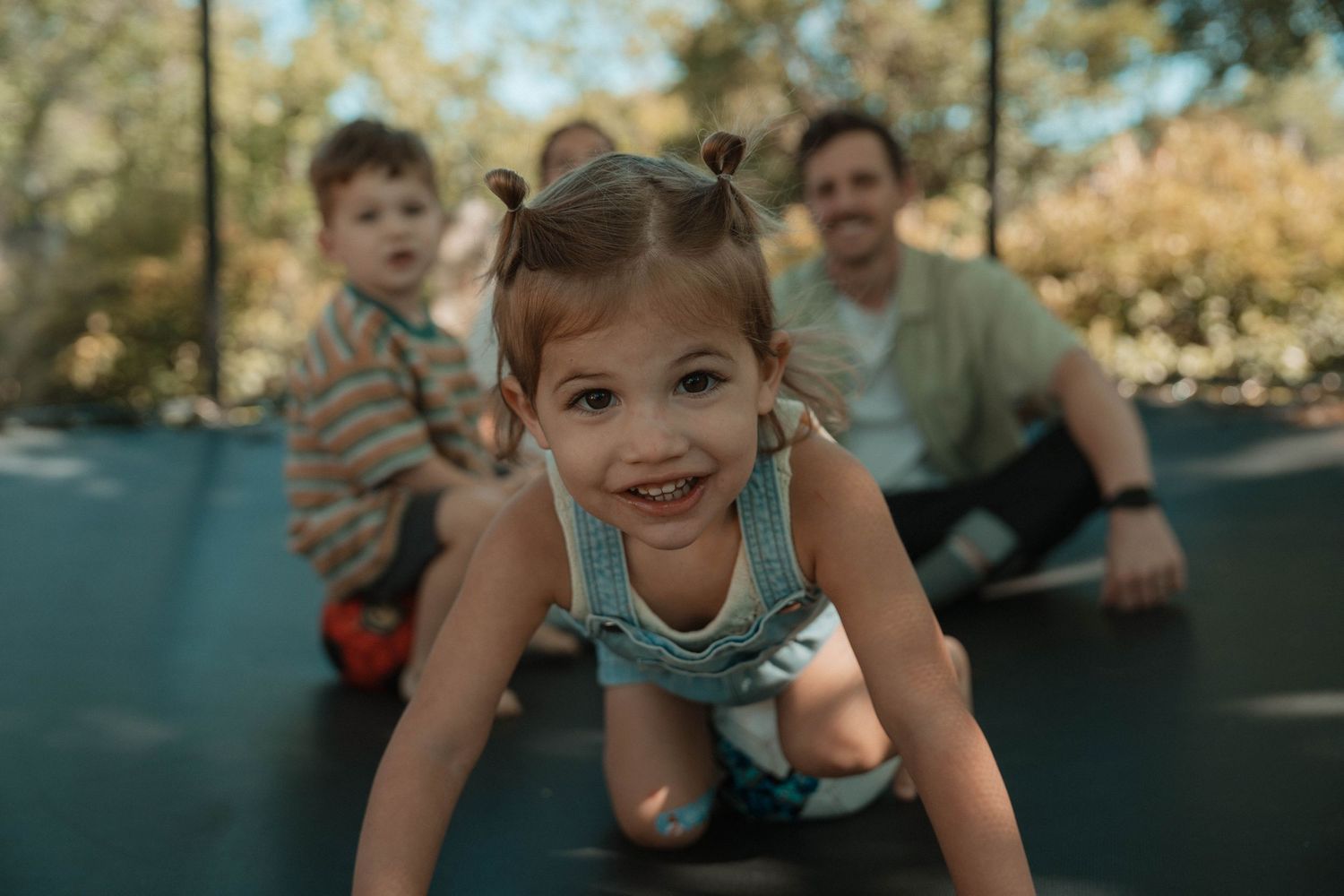 Candid outdoor family moments captured in a sequence of playful interactions.