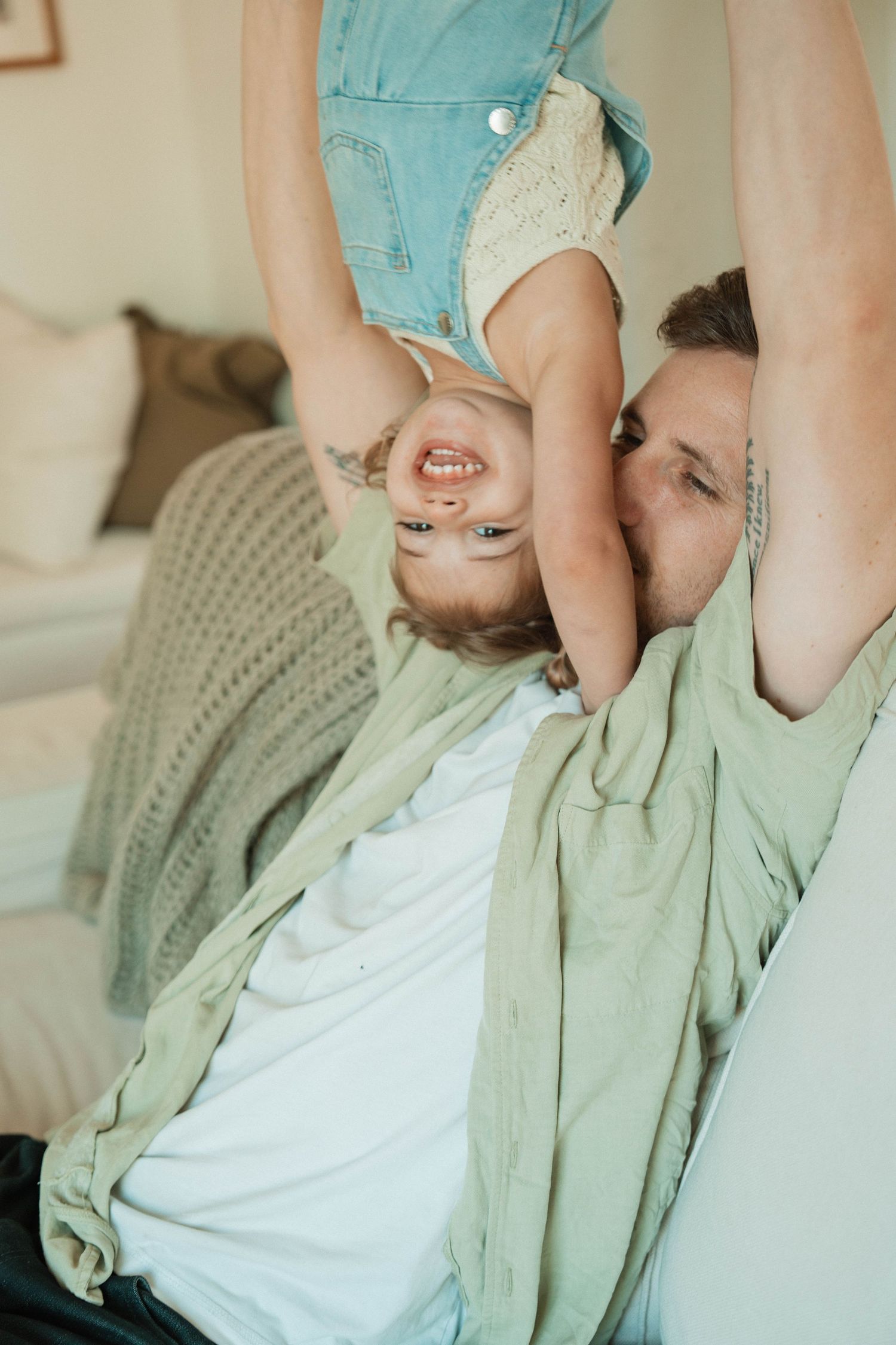 Joyful playtime moments captured on a cozy couch.