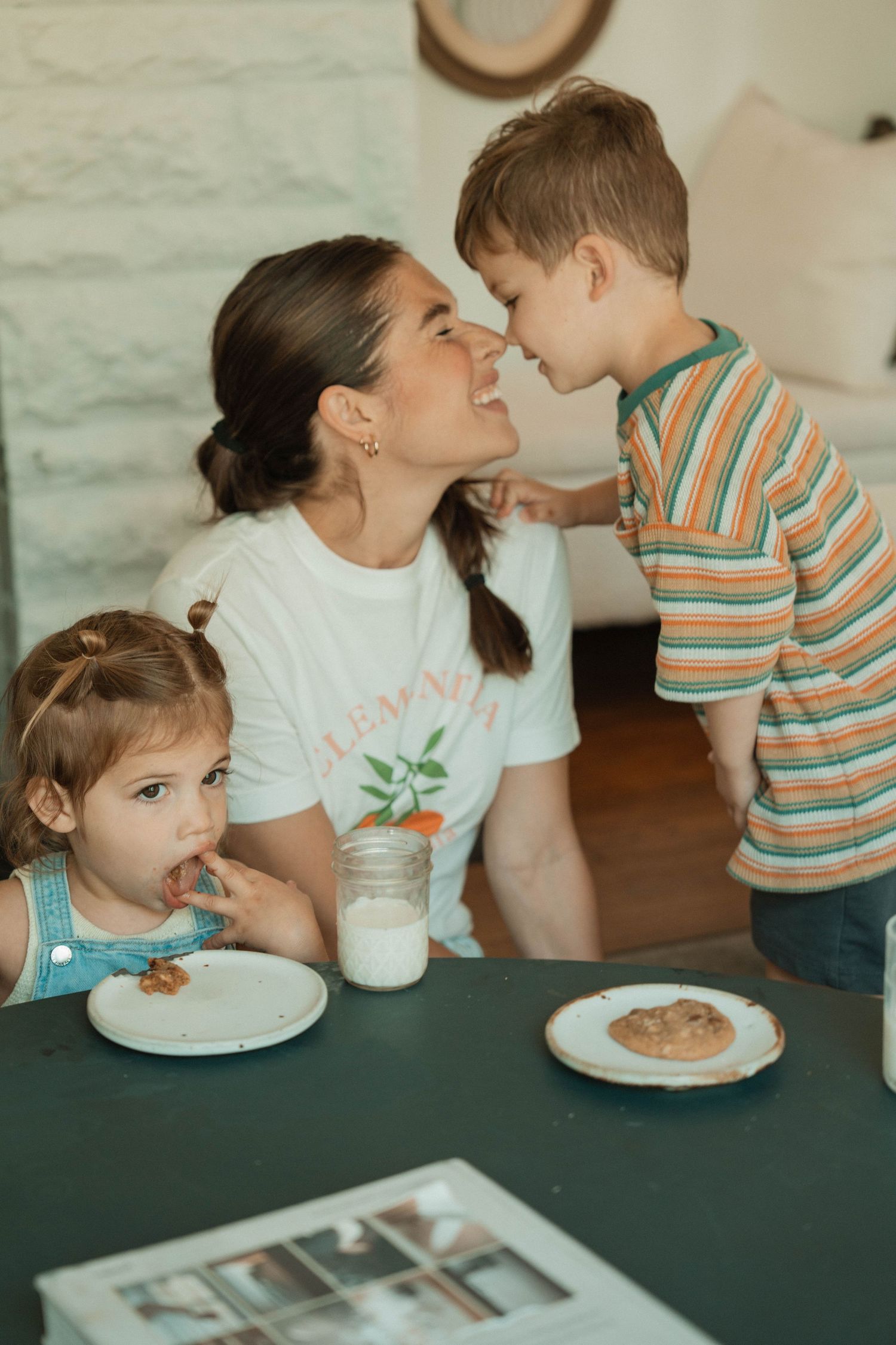 Sweet family moment shared around a table with cookies and milk.