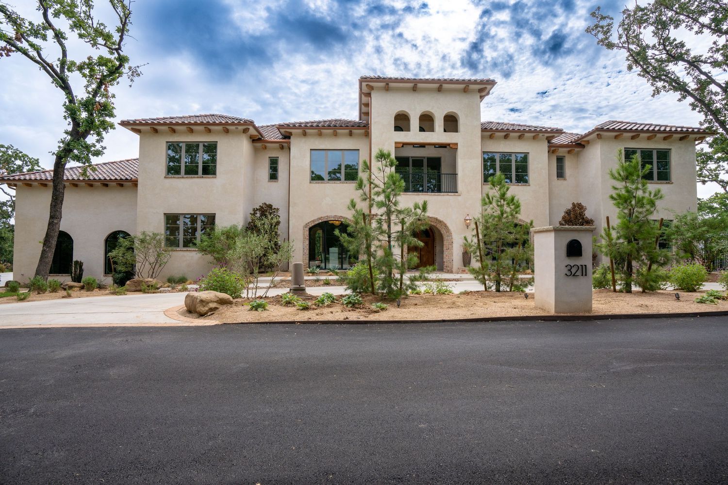 Elegant Mediterranean mansion with stucco exterior and ornate architectural details.