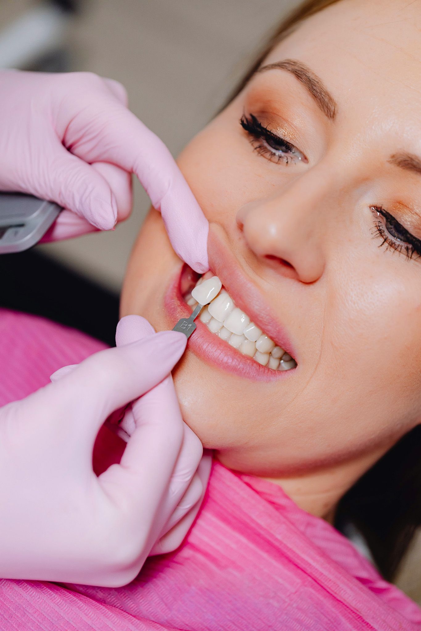 Close-up of dental examination with gloved hands checking teeth alignment.