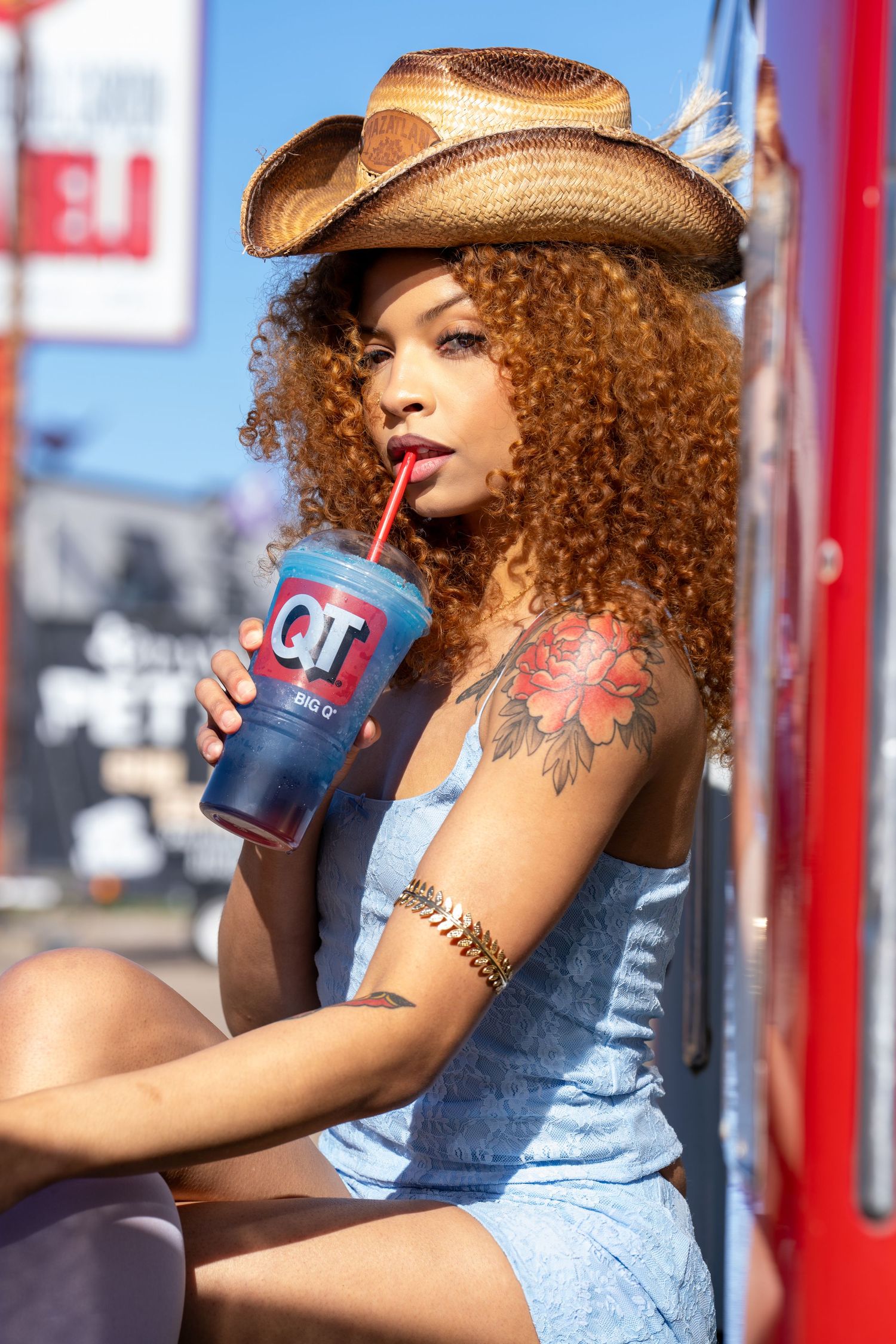 Retro Americana style photo with cowboy hat and denim at vintage gas station. DFW Photographer.