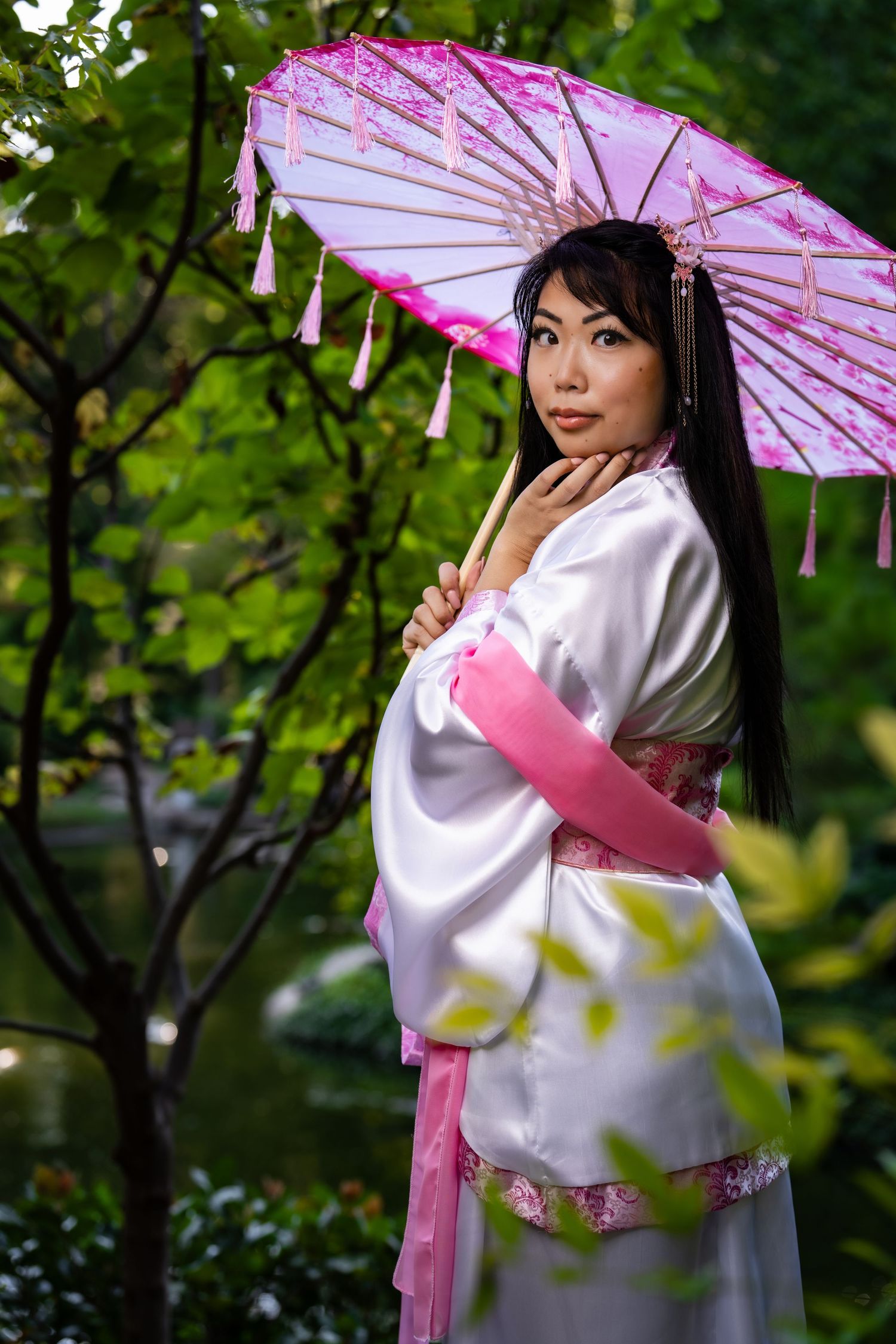 Portrait of woman in Japanese attire with pink umbrella in Japanese Garden, Fort Worth Botanic Garden, Texas by DFW Dynamic Media