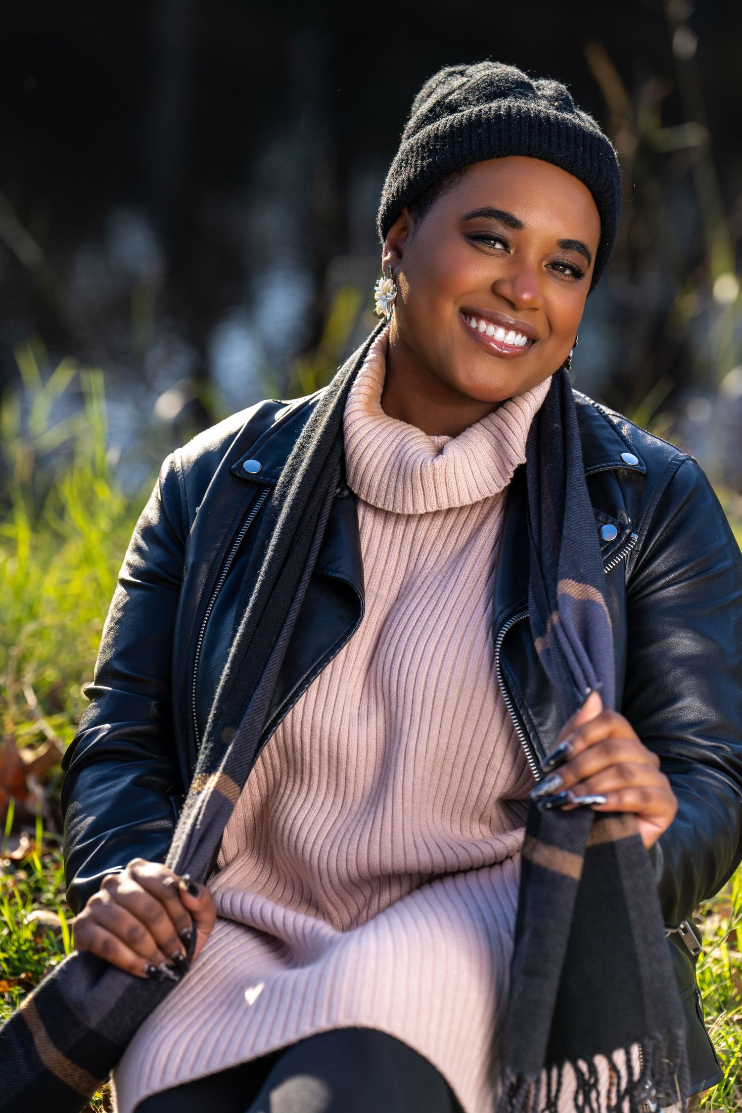 Winter fashion portrait in pink sweater and leather jacket outdoors.