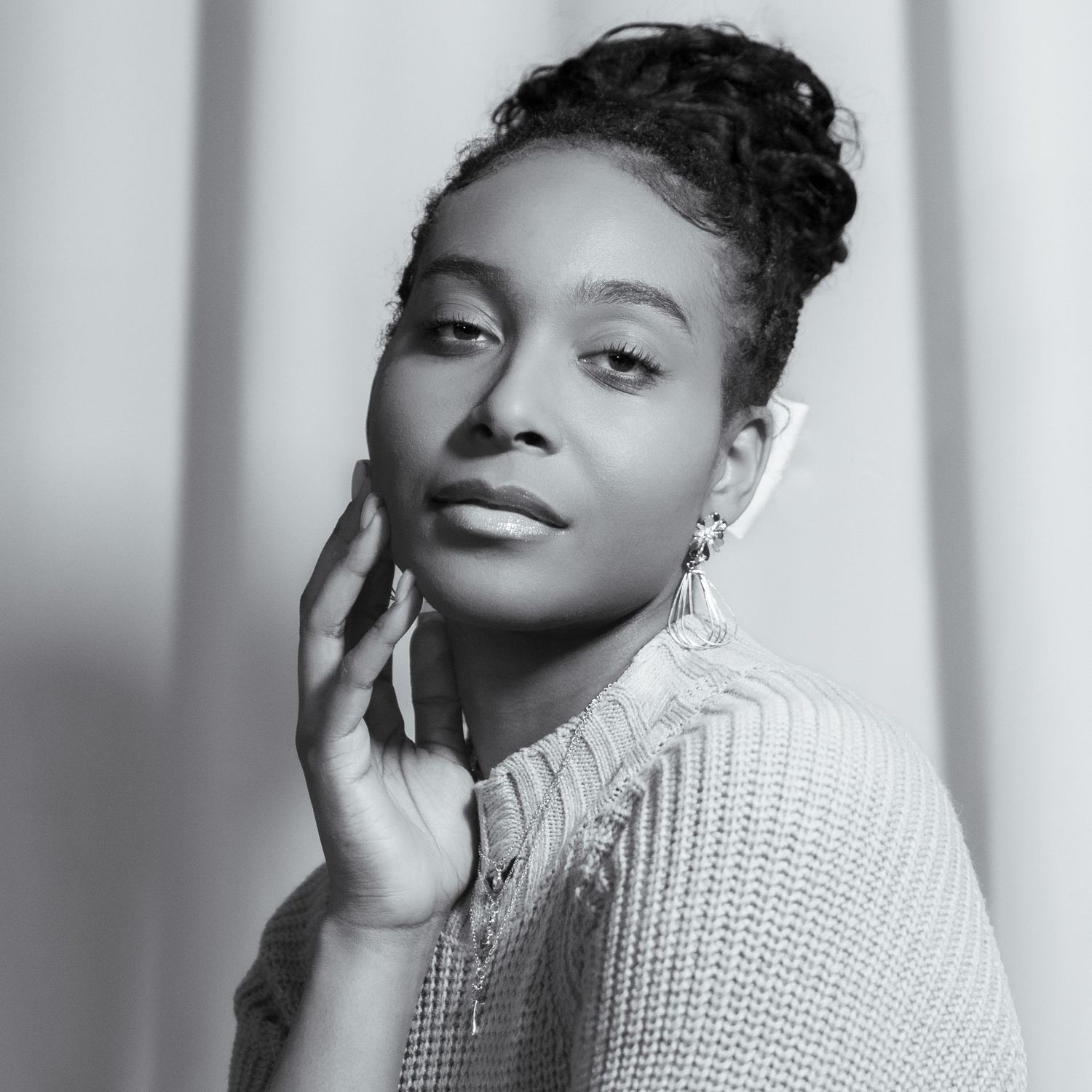 Black and white studio portraits showing artistic poses against soft lighting.