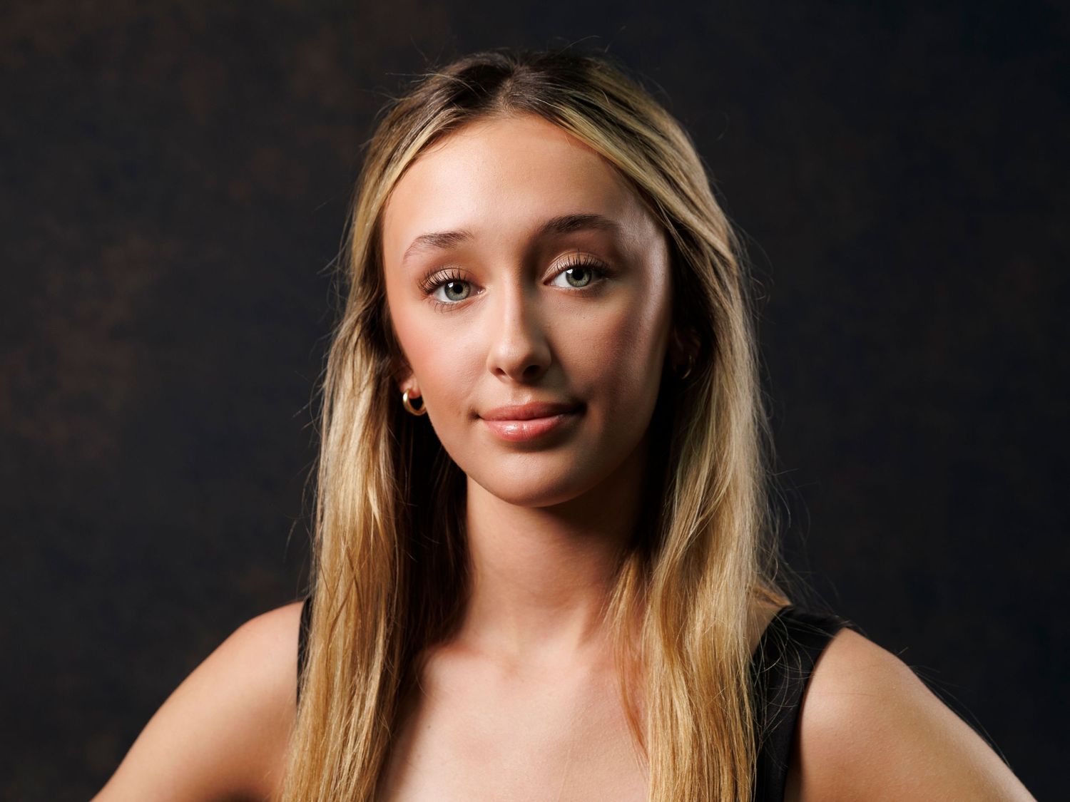Senior professional studio portraits showing different poses against a dark background.