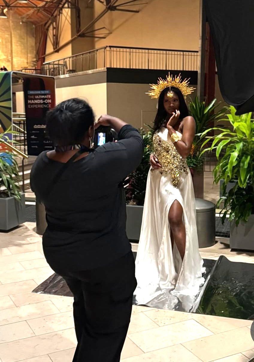 Atlanta Professional portrait photographer behind the scenes photo during session with a model in an elegant white dress and gold crown