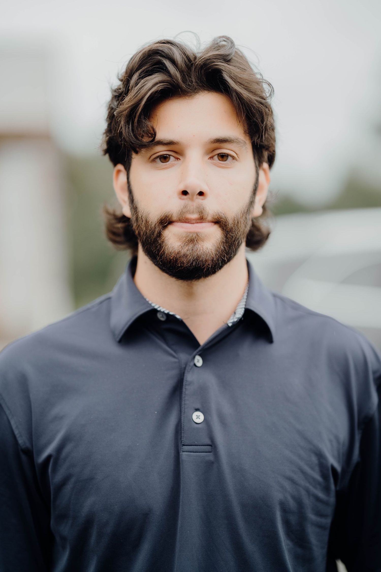 A series of headshots showing a bearded person in a dark polo shirt against a blurred background.