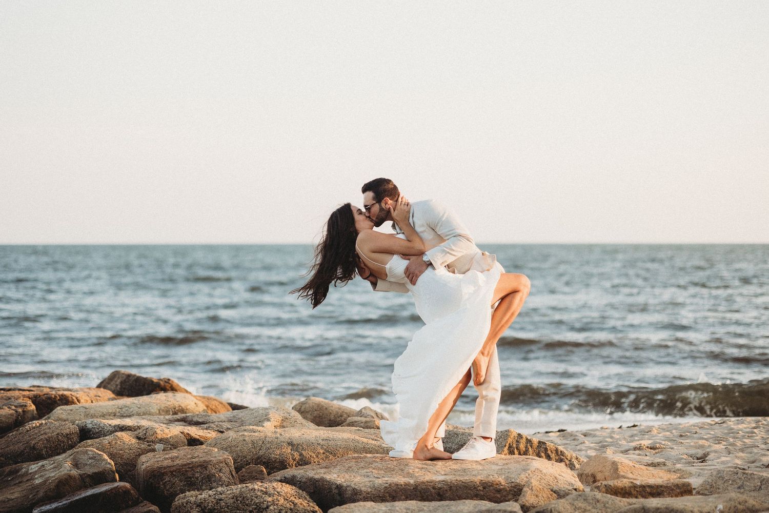 Romantic Maui portrait of newlyweds kissing while eloping by the ocean.
