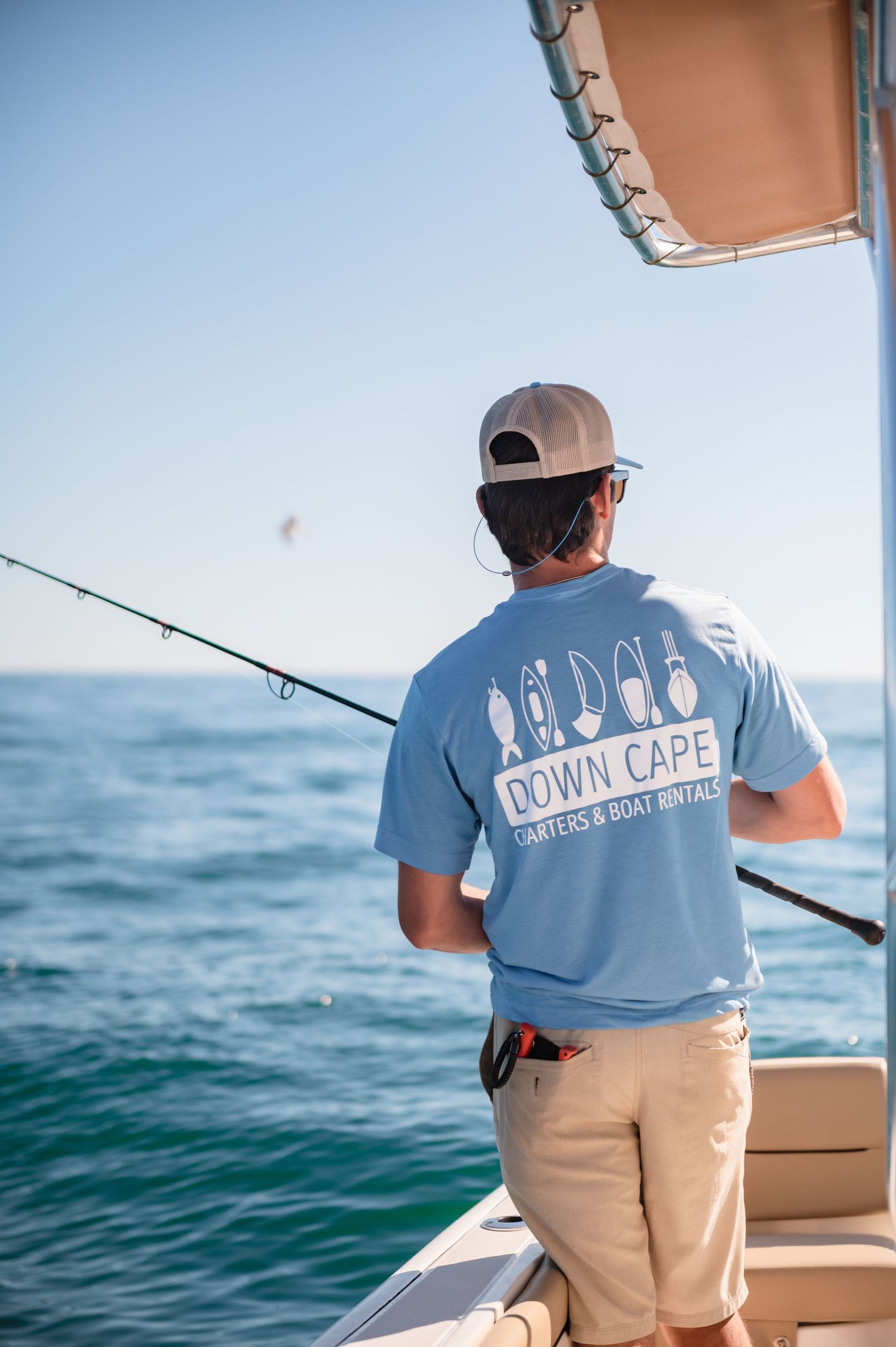 Man fishing from a boat on the open water.