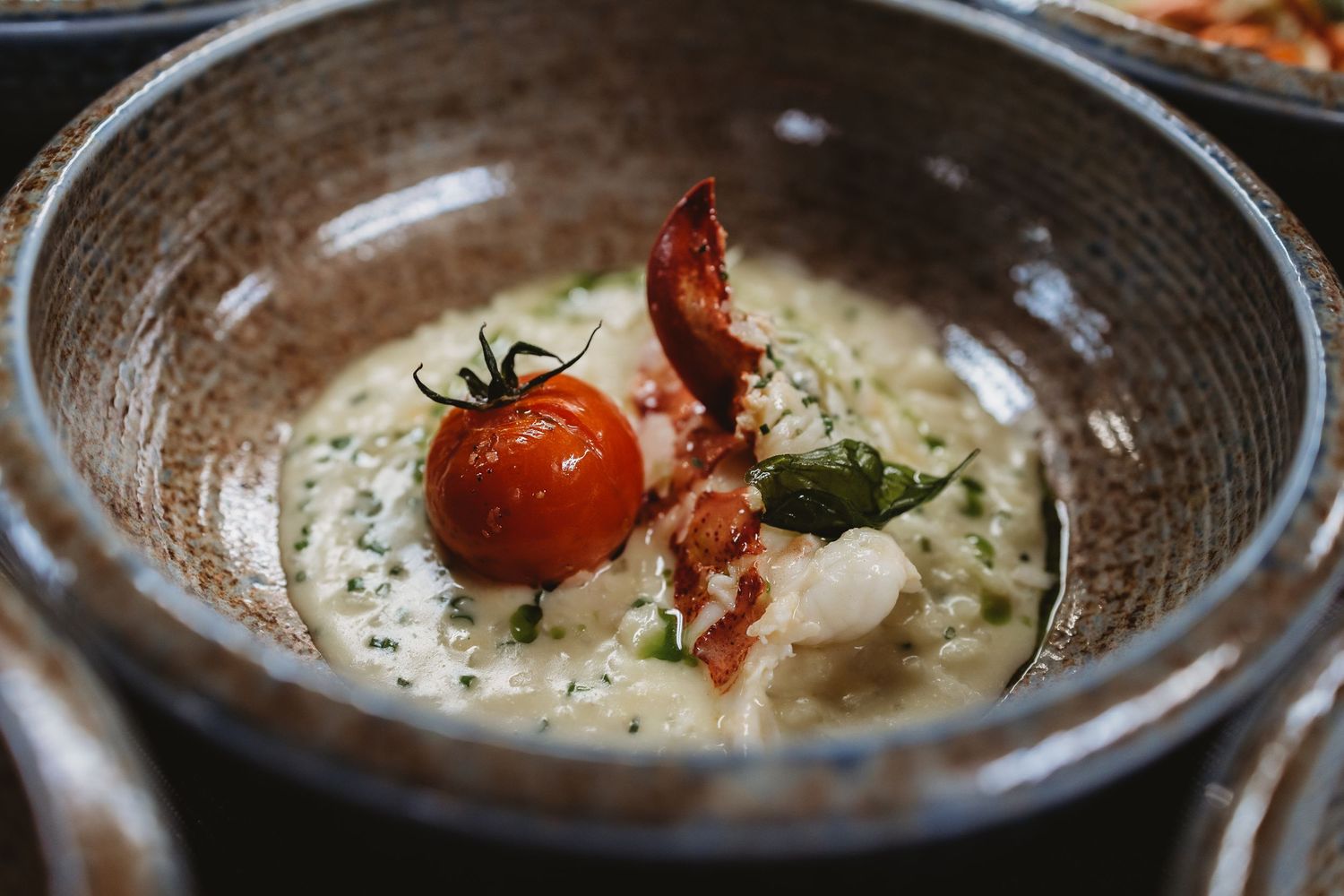 Creamy risotto topped with fresh lobster pieces.