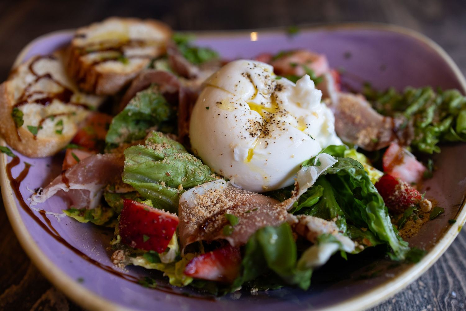 Gourmet burrata cheese salad served with crisp lettuce, styled for Maui cuisine photography.