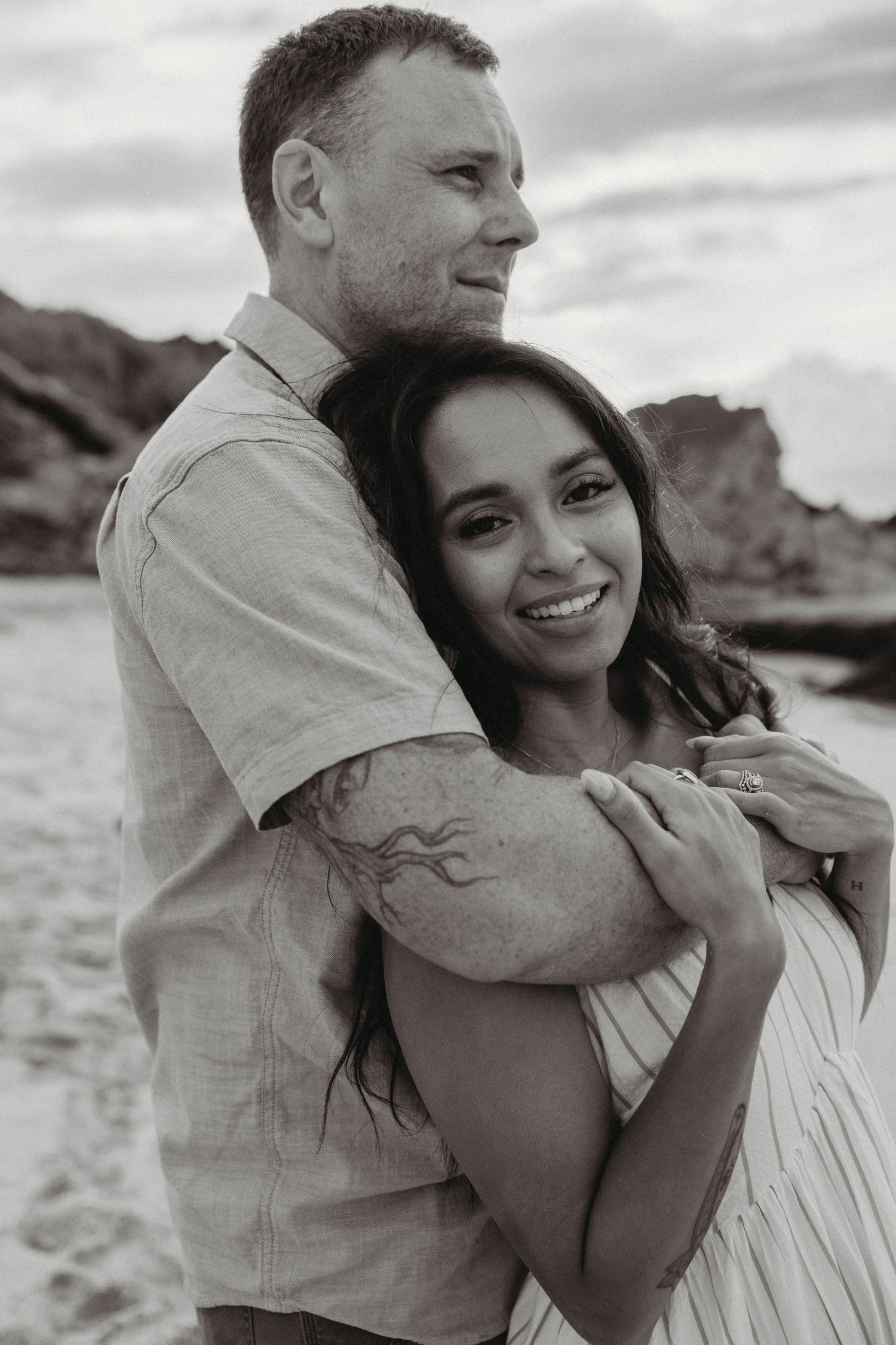 Maui couples photography of a couple standing by the ocean facing out to sea.