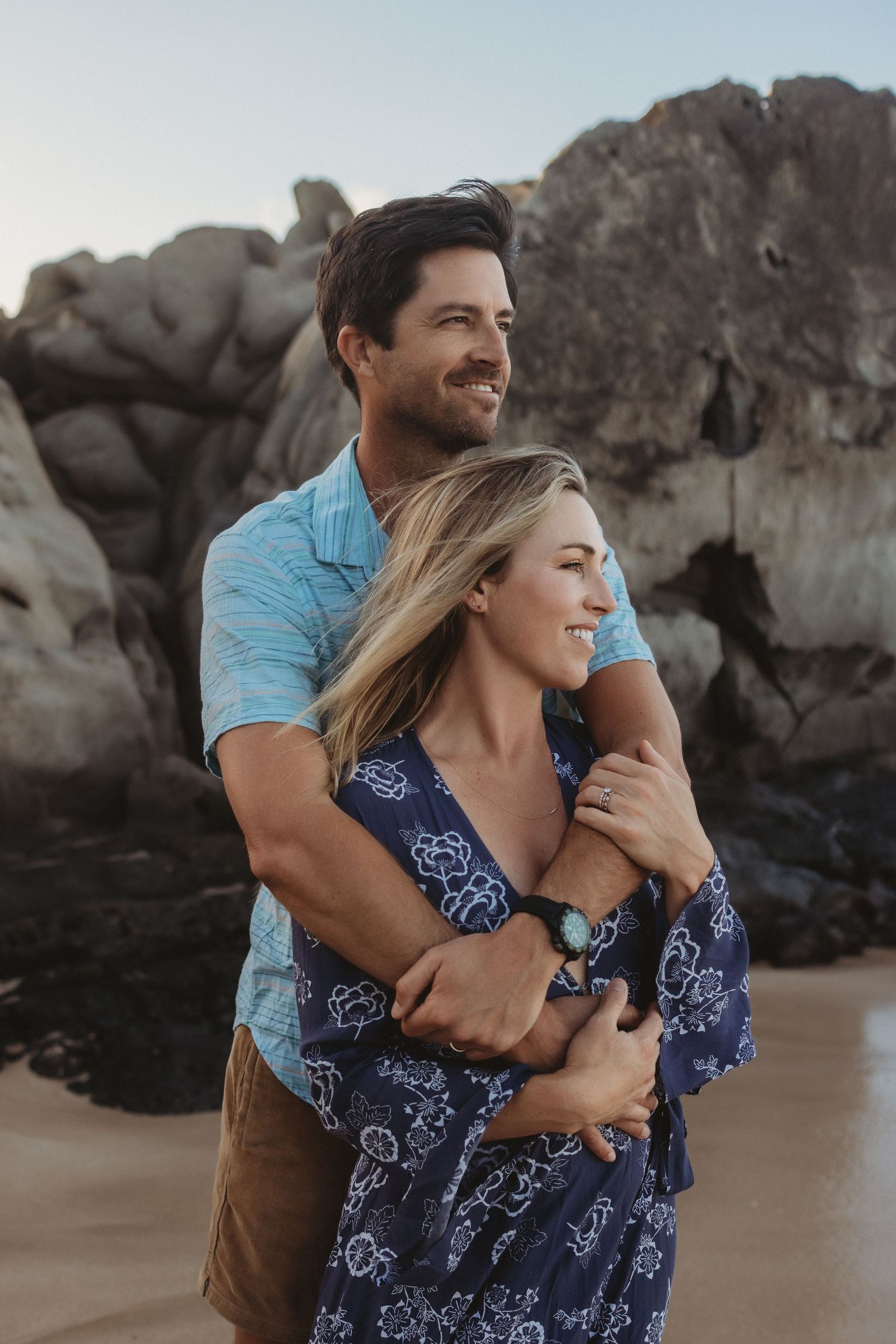 Maui couples photography of a couple standing by the ocean facing out to sea.