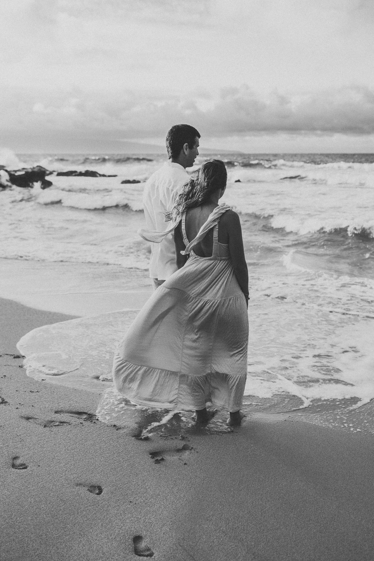 Romantic Maui elopement portrait of bride and groom looking out at the sea.