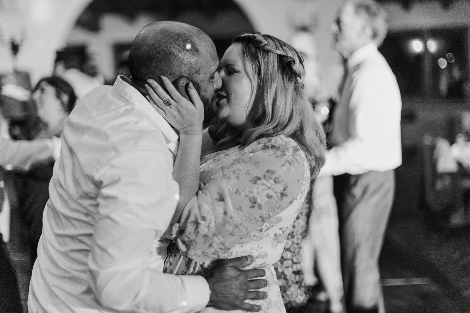 Wedding reception dance floor filled with guests celebrating in black and white.