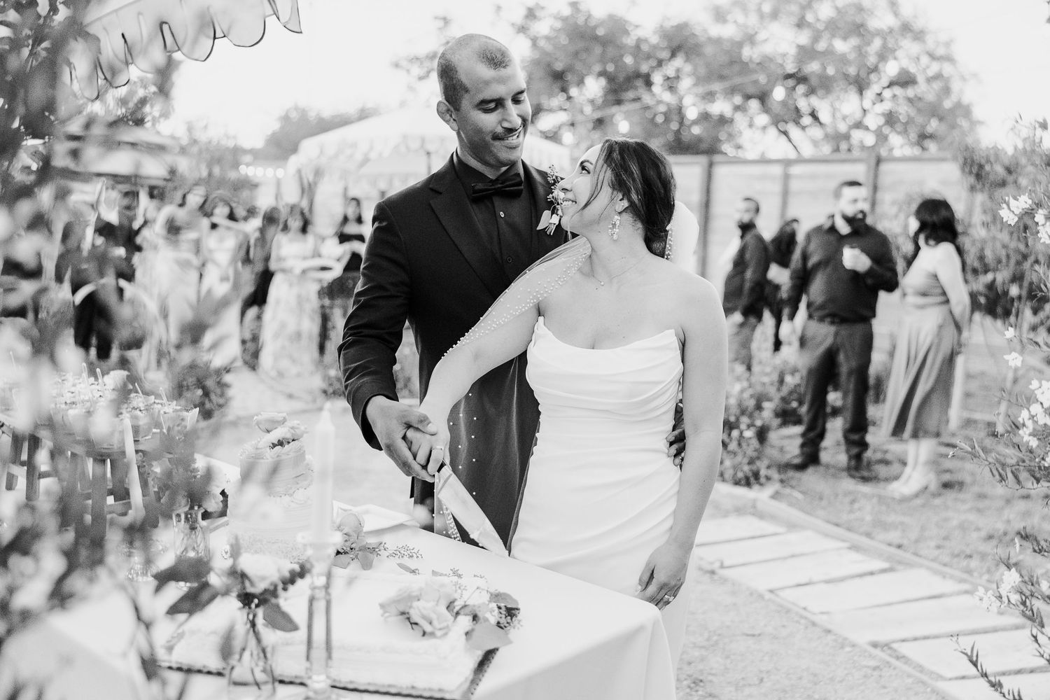 Wedding celebration candid moments captured in black and white at an outdoor venue.