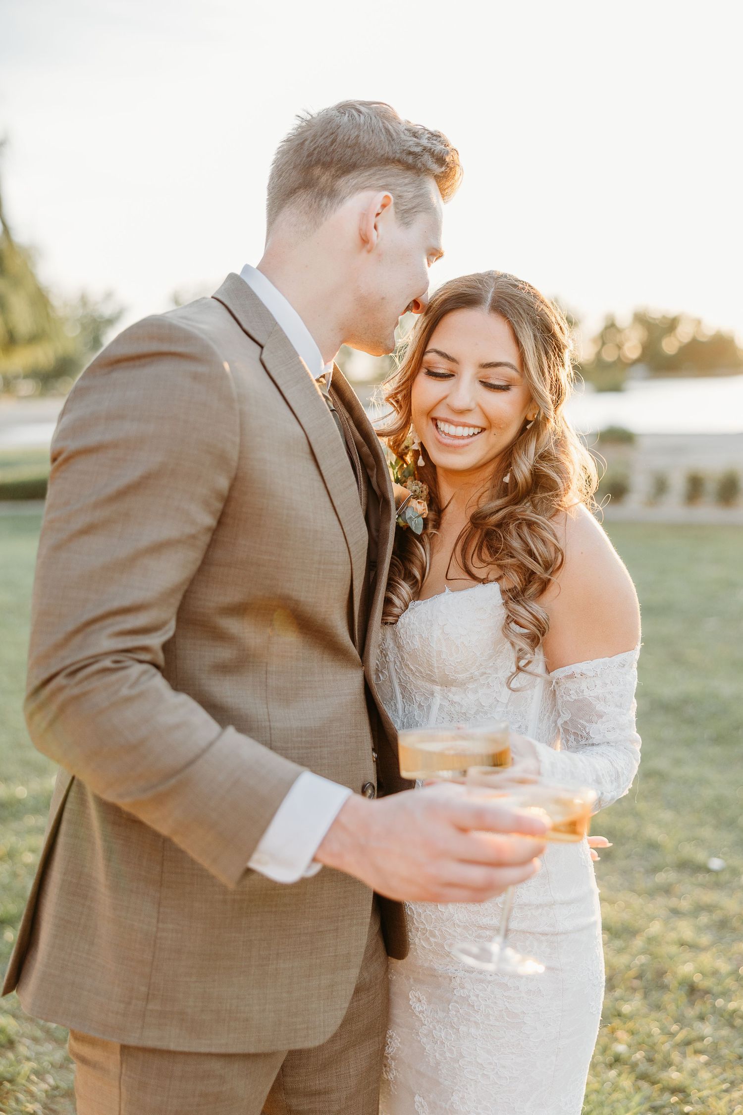 A couple shares an intimate moment during their sunset wedding celebration.