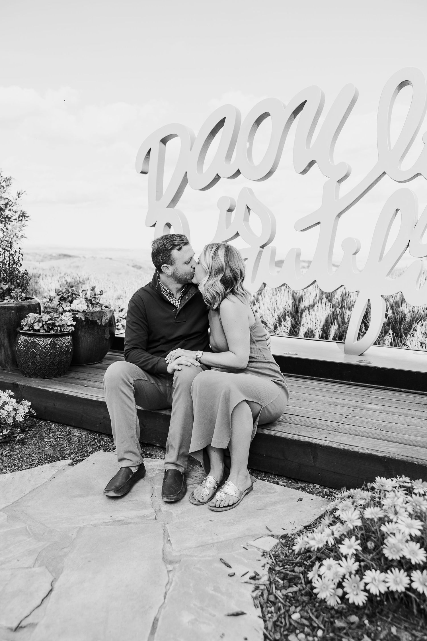 Black and white series of couples sitting and sharing intimate moments on outdoor garden bench.