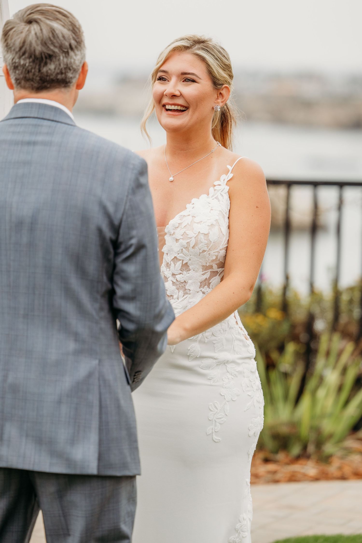 Joyful wedding moment shared on waterfront deck.