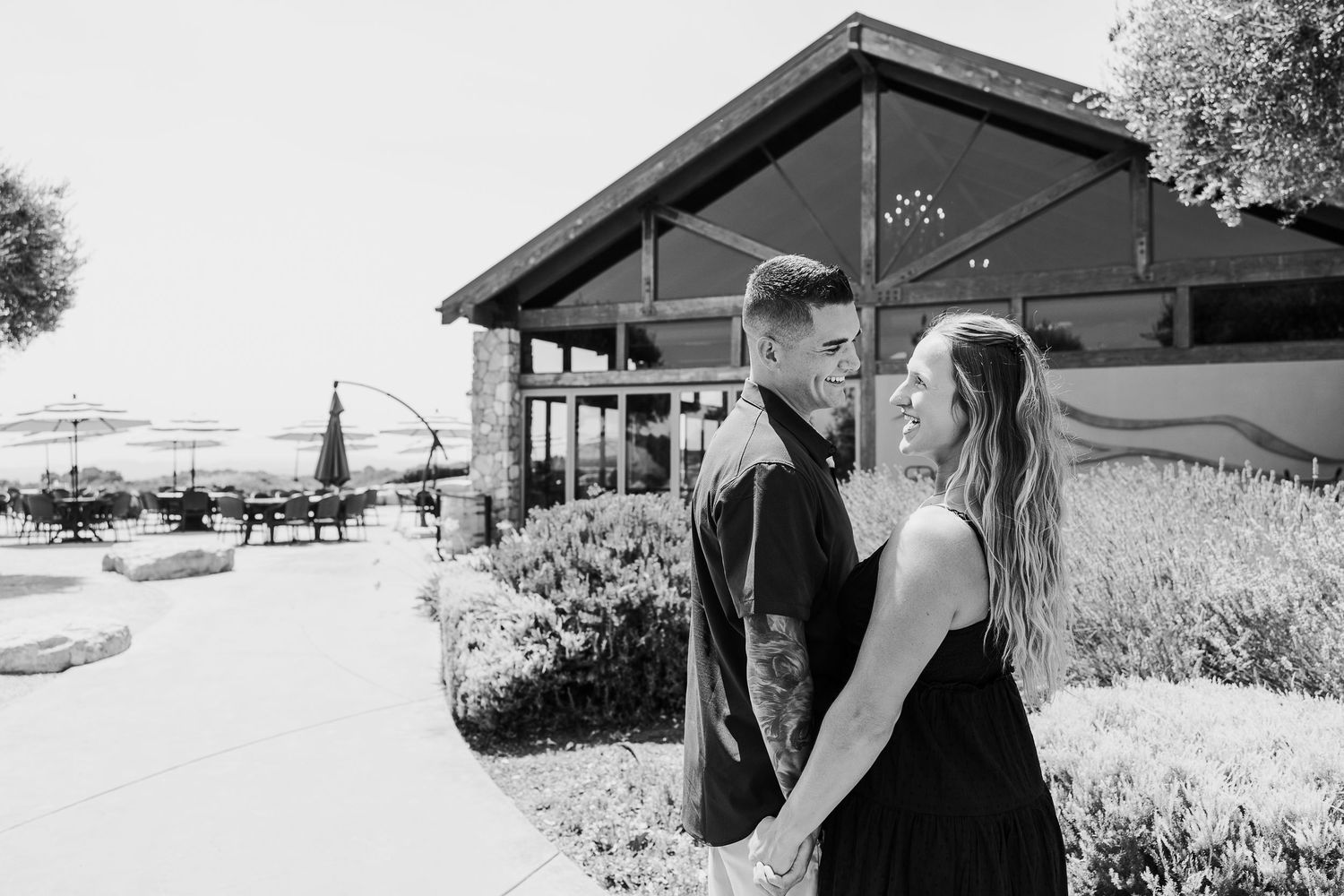 Black and white photo series capturing candid moments between two people in an outdoor setting.