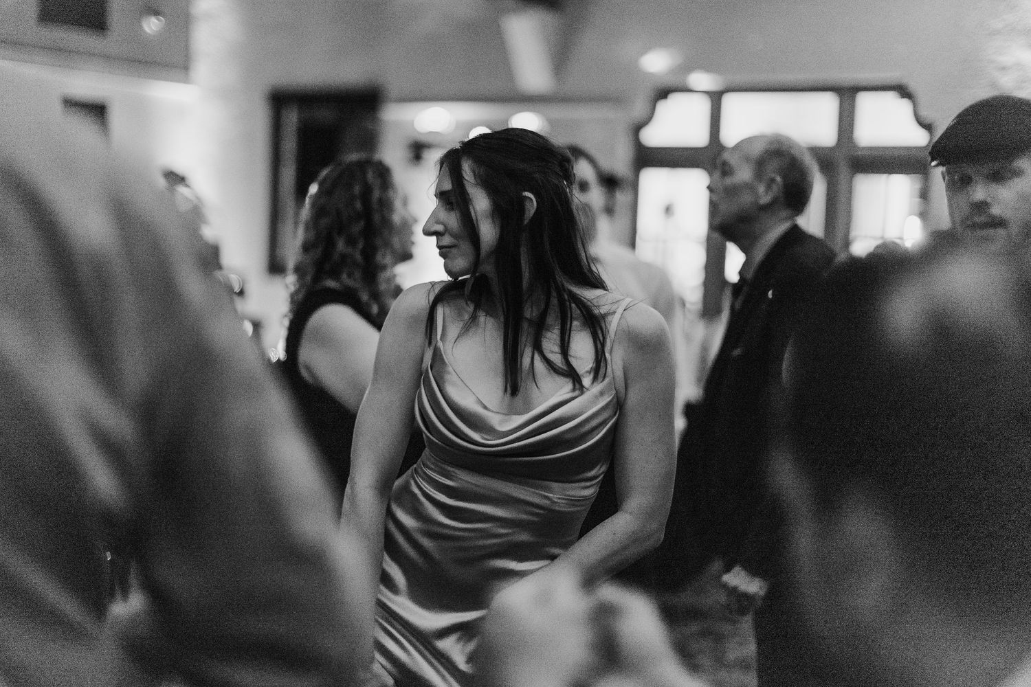 Dance floor moments captured in black and white during evening wedding reception.
