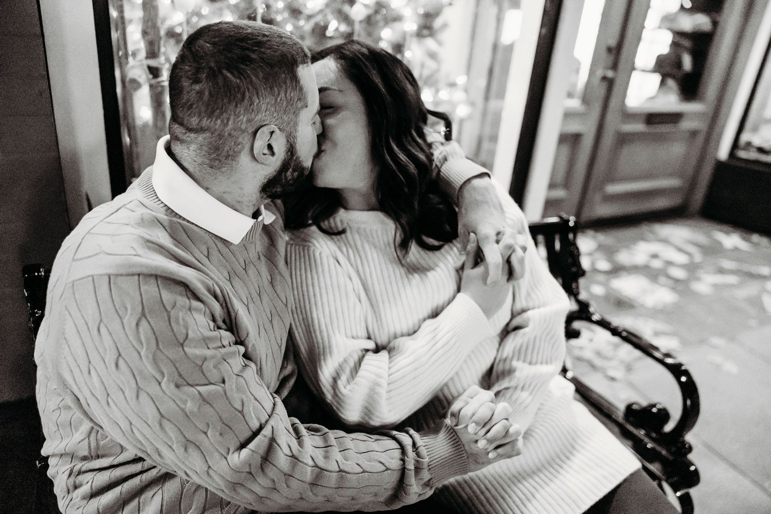 A romantic black and white photo collage showing tender moments between a couple embracing and kissing.
