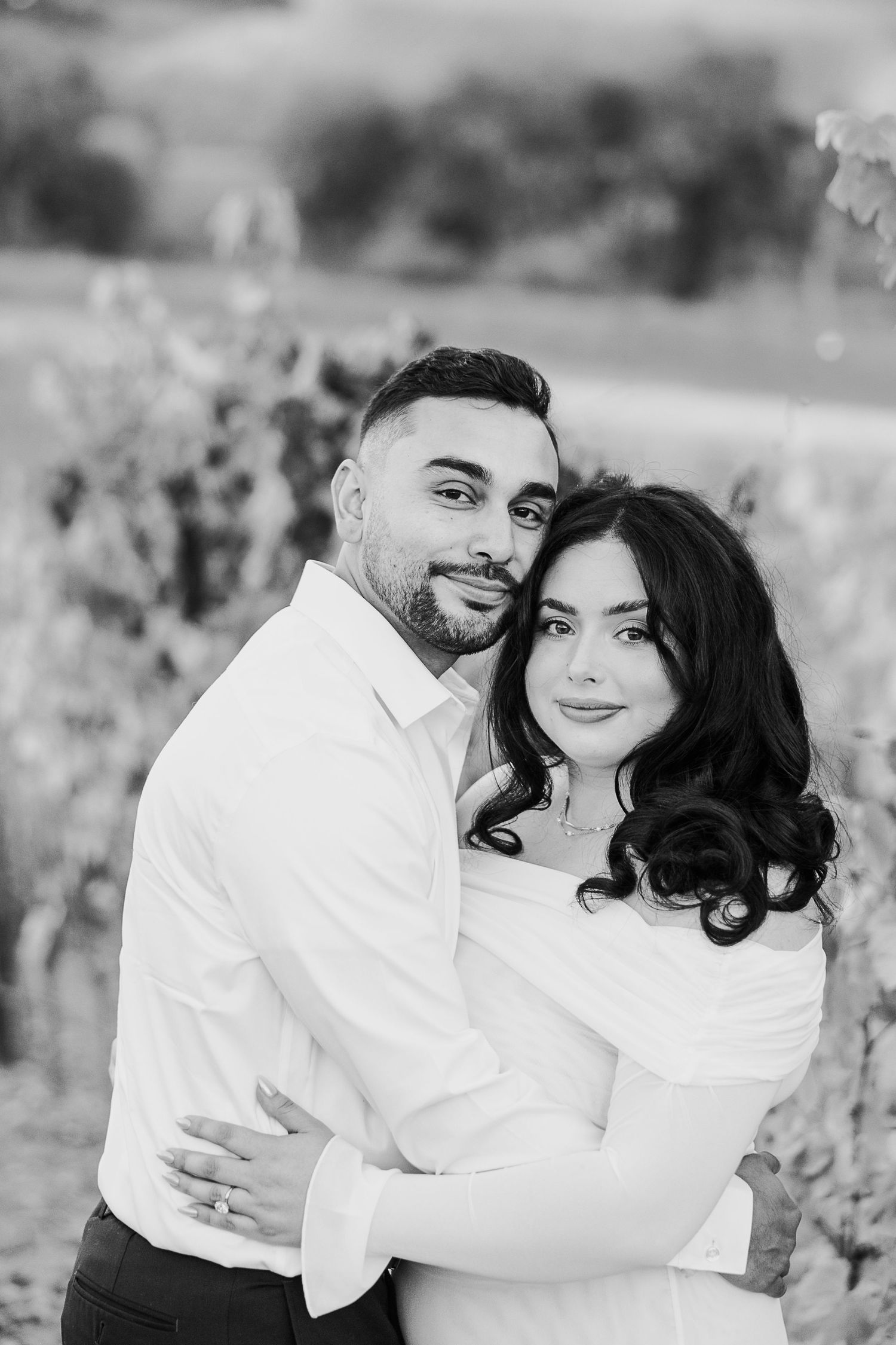 Black and white romantic couple portraits in intimate outdoor setting.
