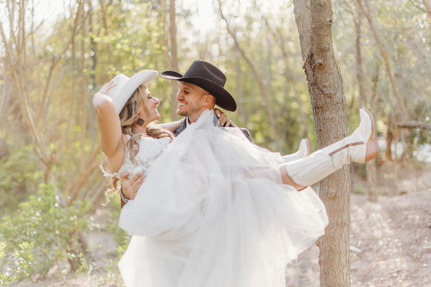 A bride twirls her white dress in a dreamy wooded setting with natural light filtering through.