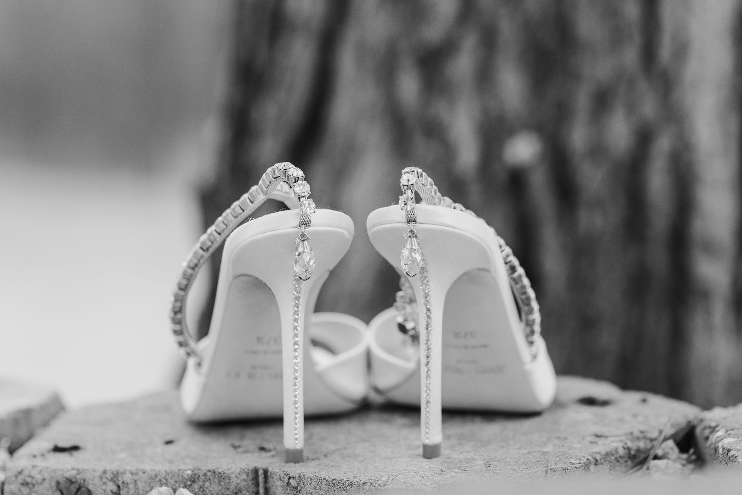 A series of elegant white bridal shoes photographed at different angles on a textured surface.
