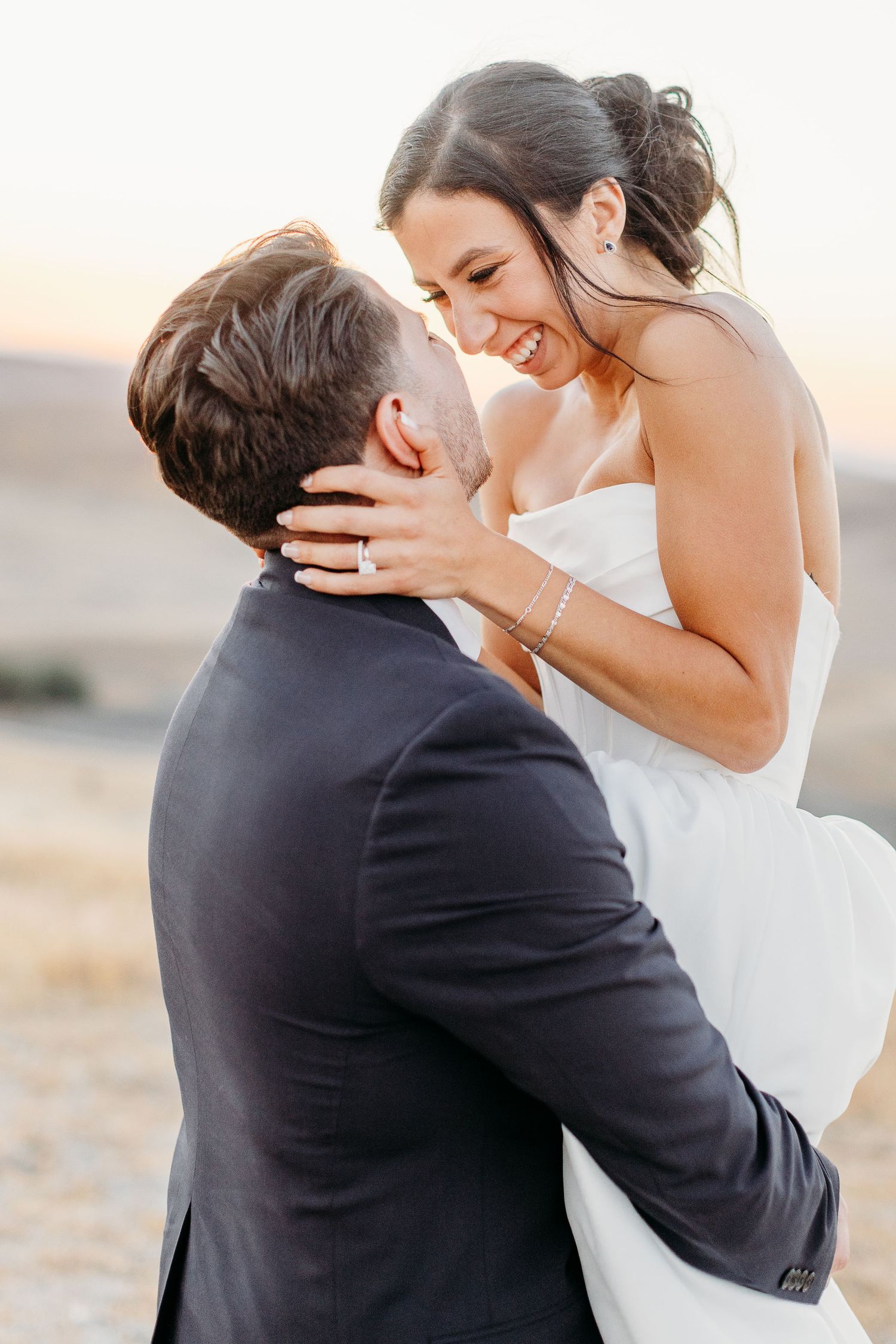 A romantic sequence of wedding couple embracing and kissing in black suit and white dress.
