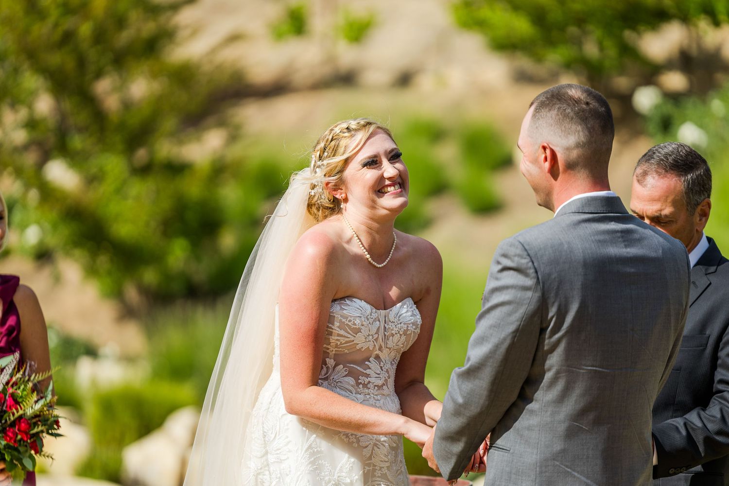 An outdoor wedding ceremony moment against a natural desert landscape backdrop.