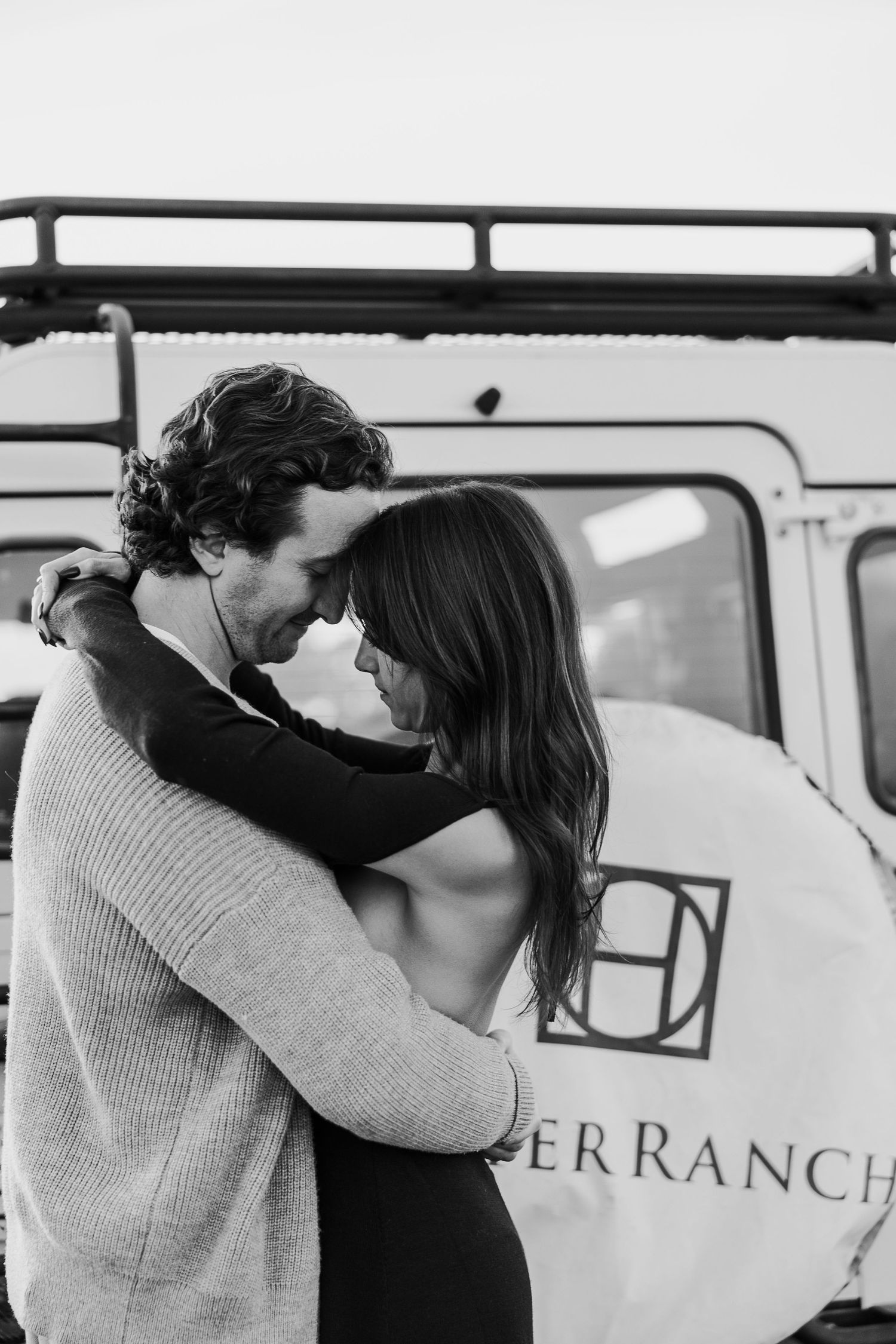 Black and white photos of intimate moments by vintage van with Deer Ranch signage.