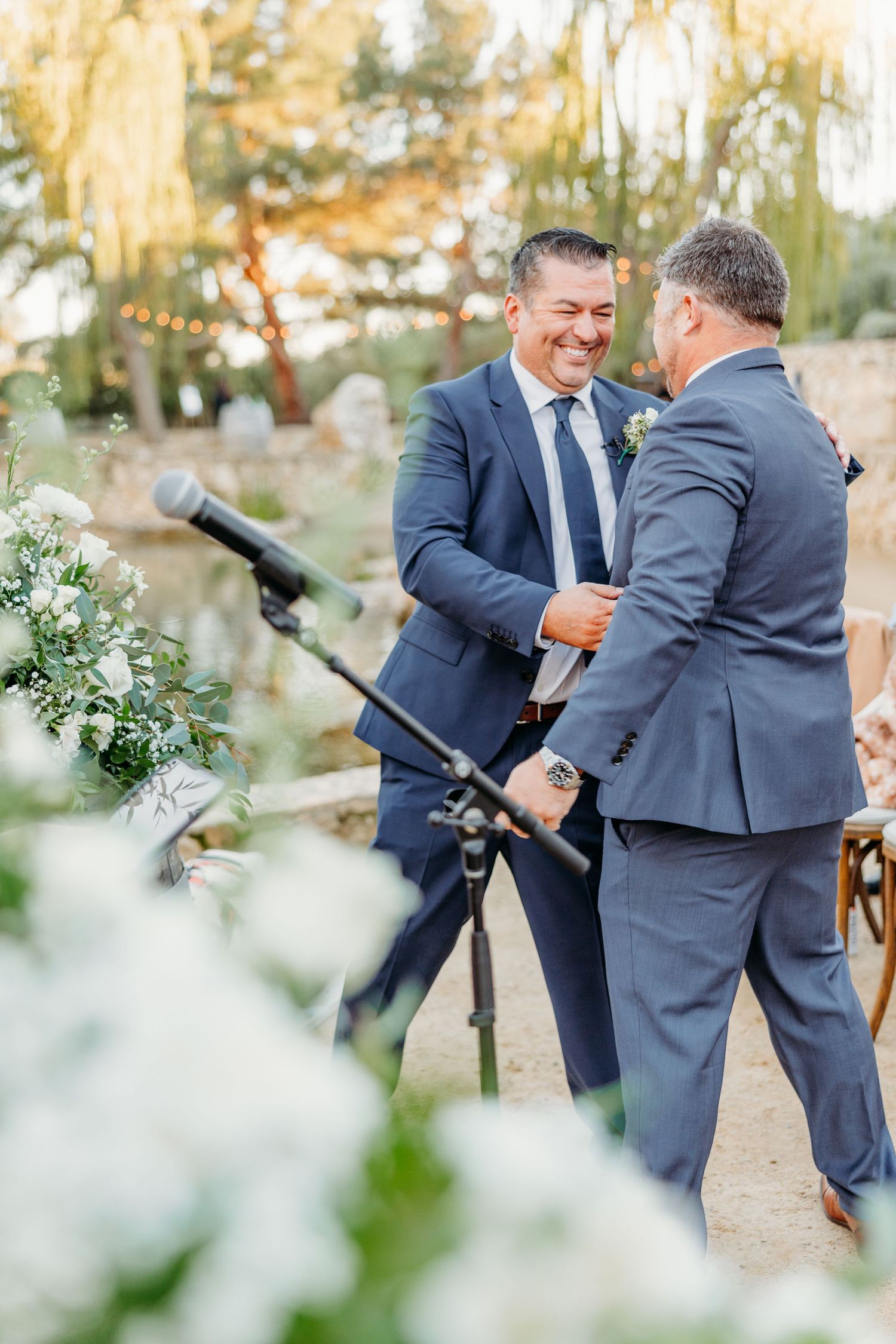 Wedding party members playfully interacting during outdoor photo session.