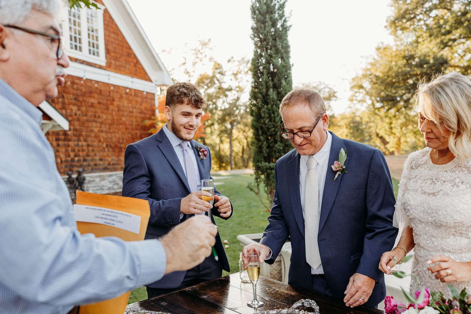 Guests enjoying drinks and conversation during outdoor wedding reception.