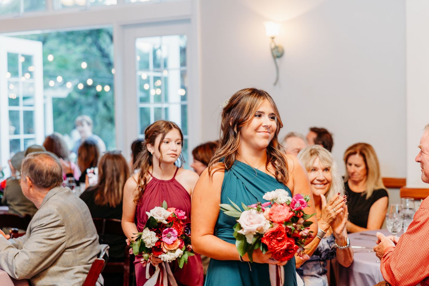 Wedding celebration with guests enjoying the reception in a bright indoor venue.